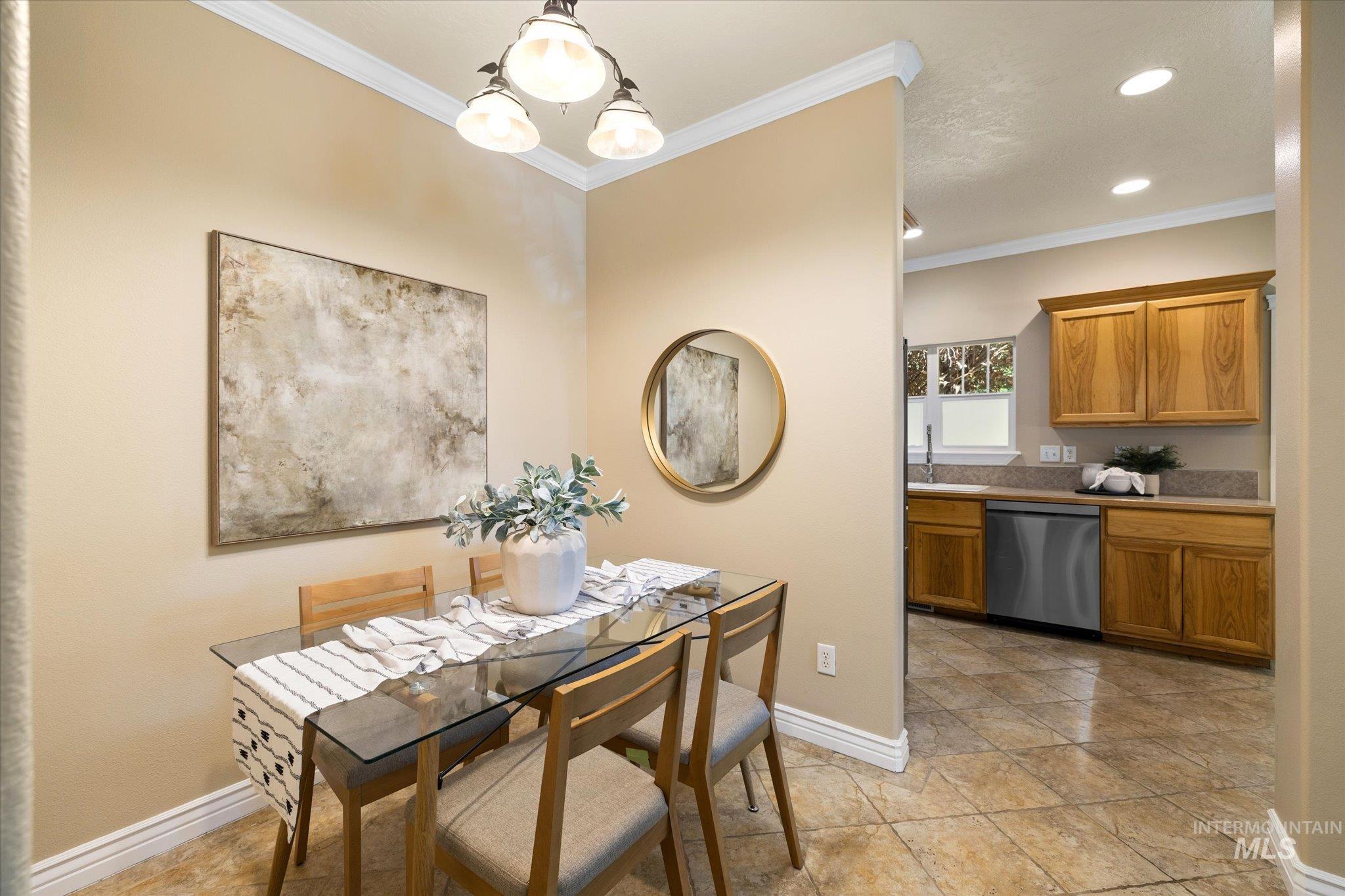 Dining area with crown molding, recessed lighting, and a chandelier