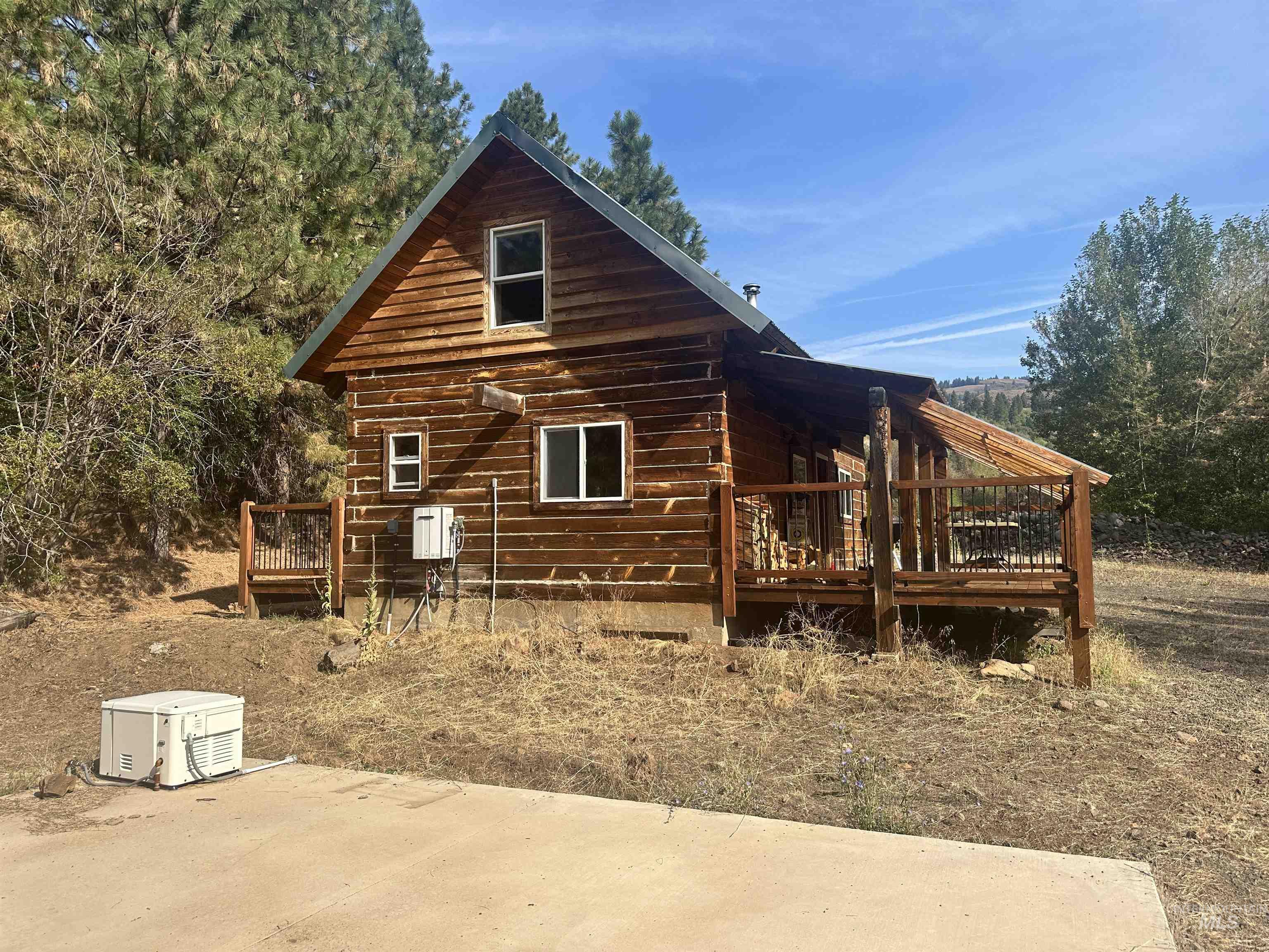 View of side of property with a wooden deck