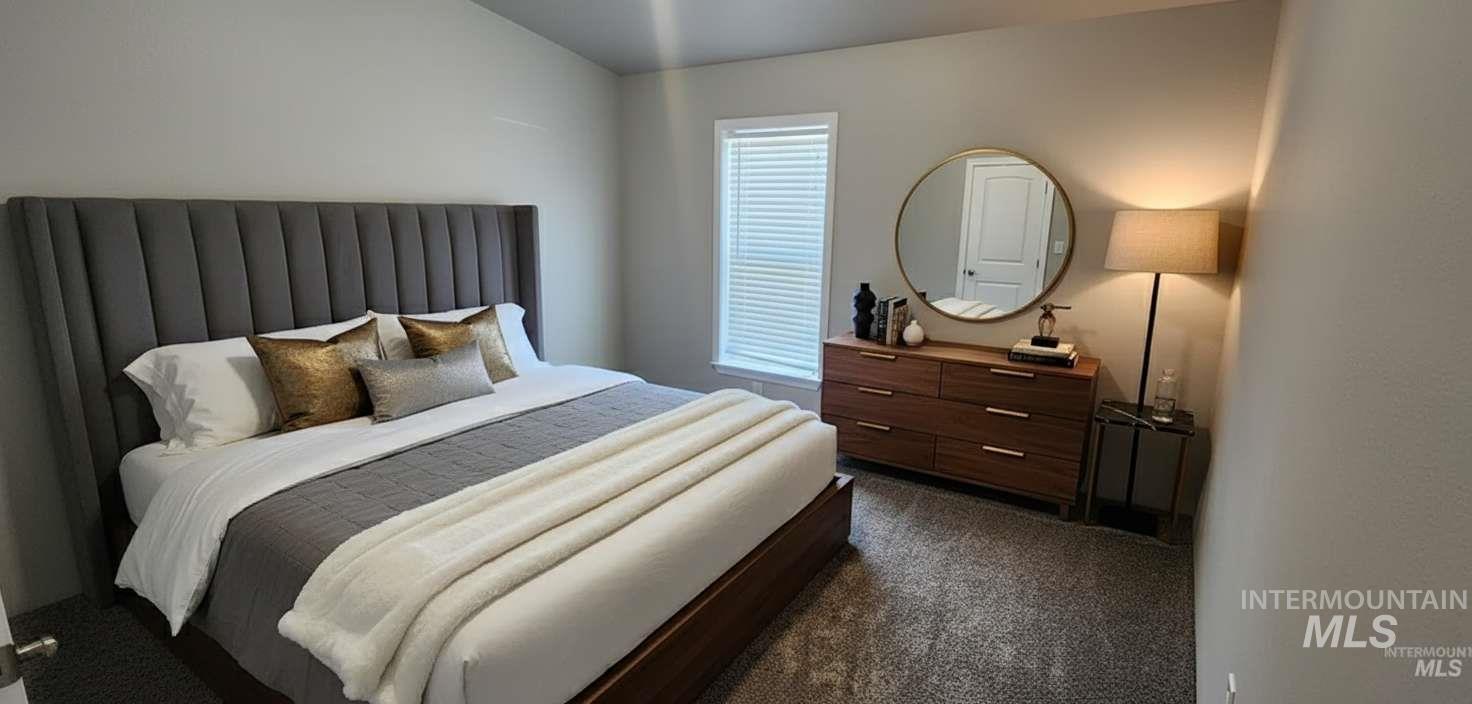 Bedroom featuring dark carpet