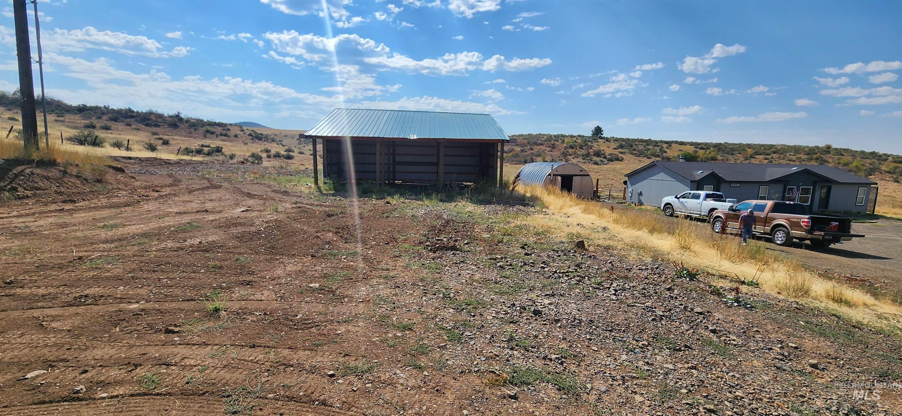 View of yard featuring a pole building, an outdoor structure, and a view of countryside