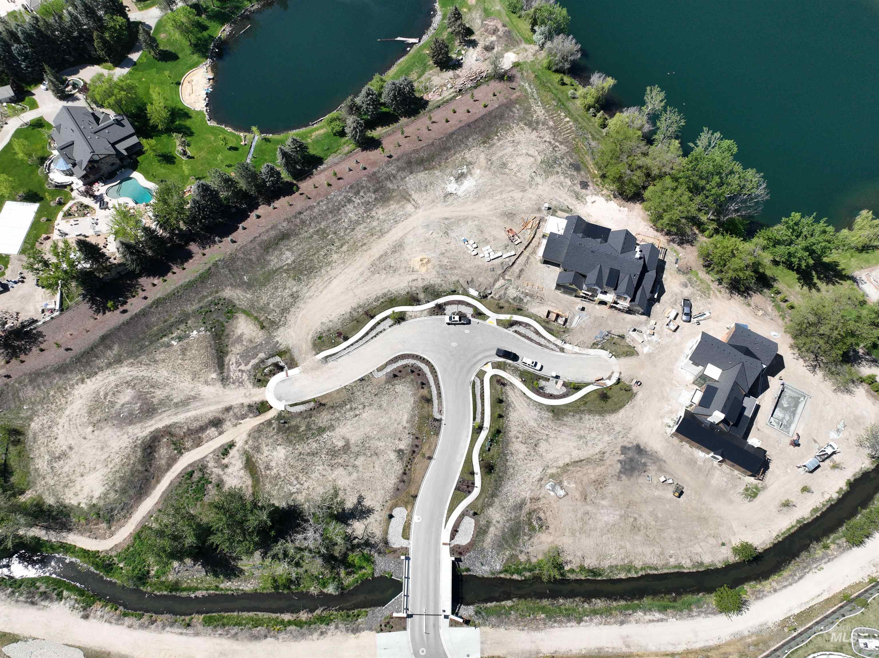 Aerial view of property's location with a large body of water