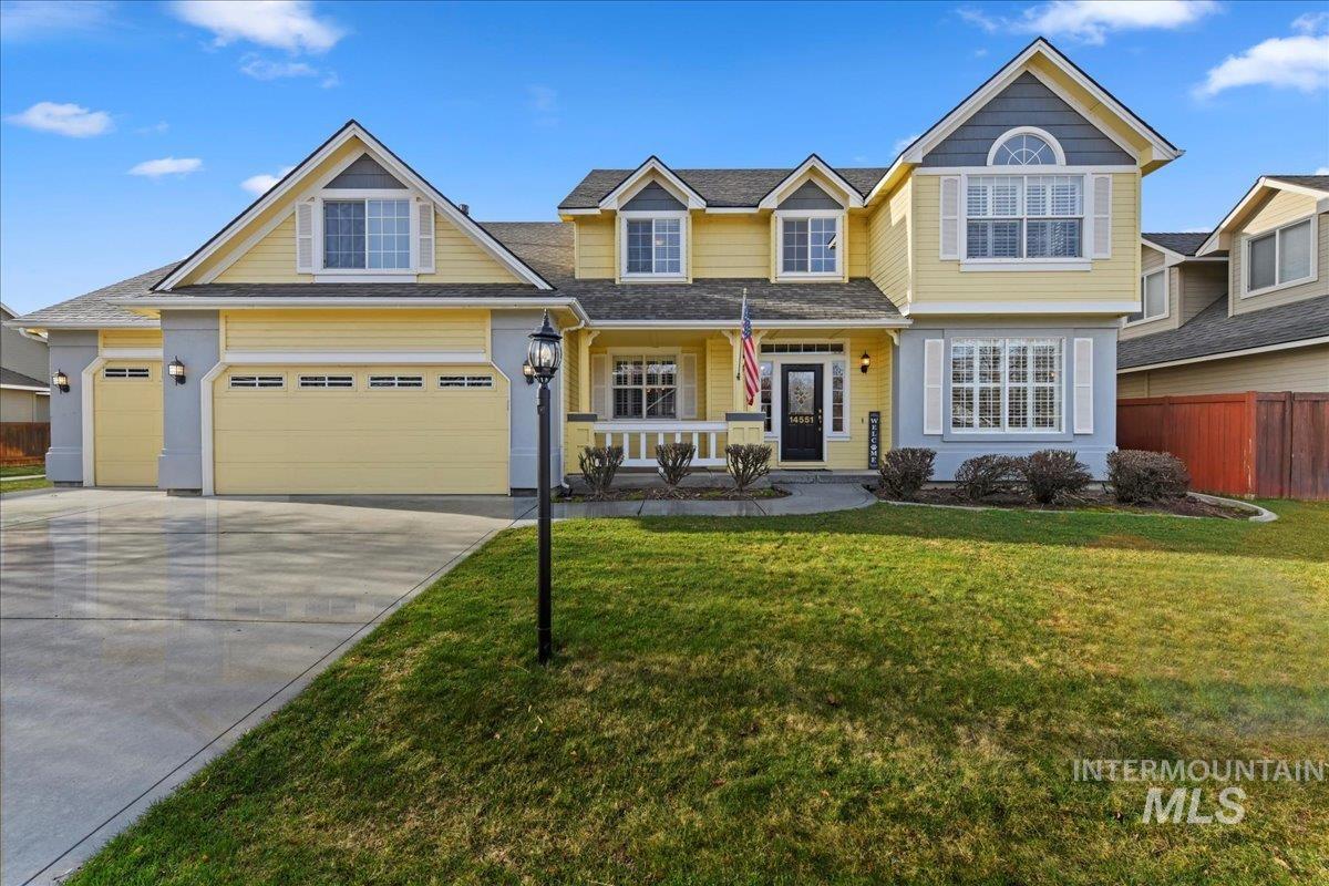 View of front of home with covered porch, concrete driveway, and an attached garage
