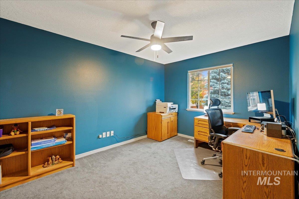 Office featuring light carpet, a textured ceiling, and ceiling fan