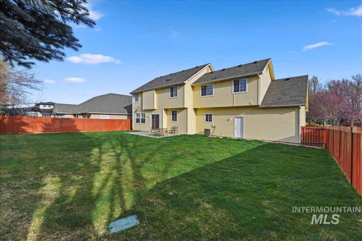 Rear view of property featuring a fenced backyard and a patio area