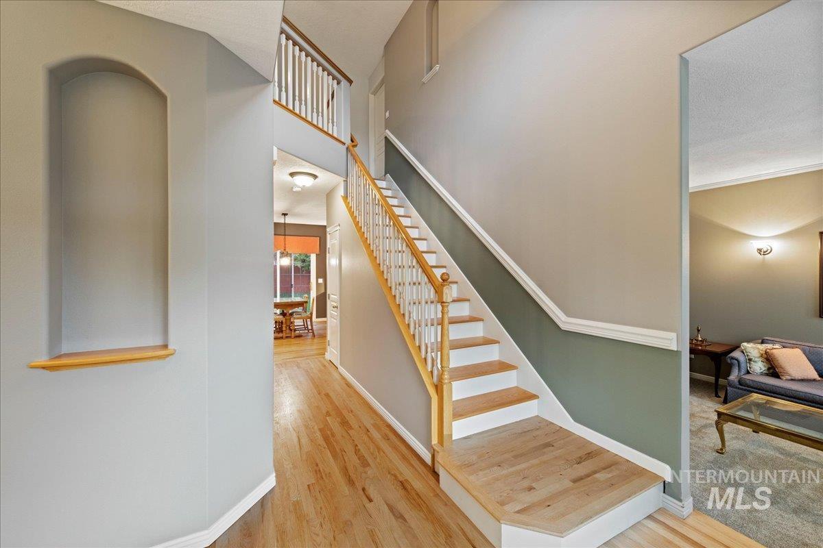 Staircase featuring wood finished floors and baseboards