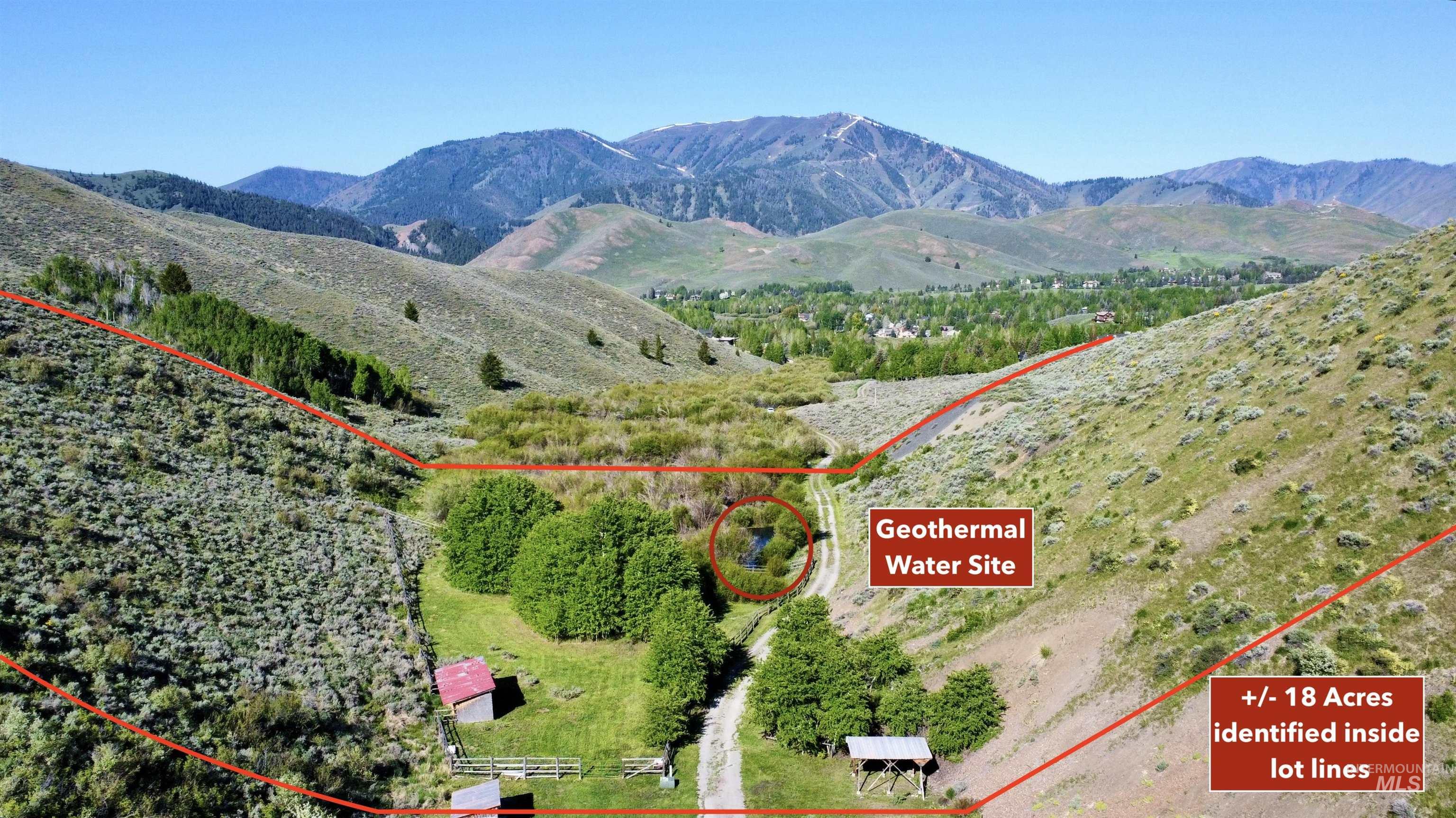 Aerial overview of property's location with a mountainous background and property parcel outlined