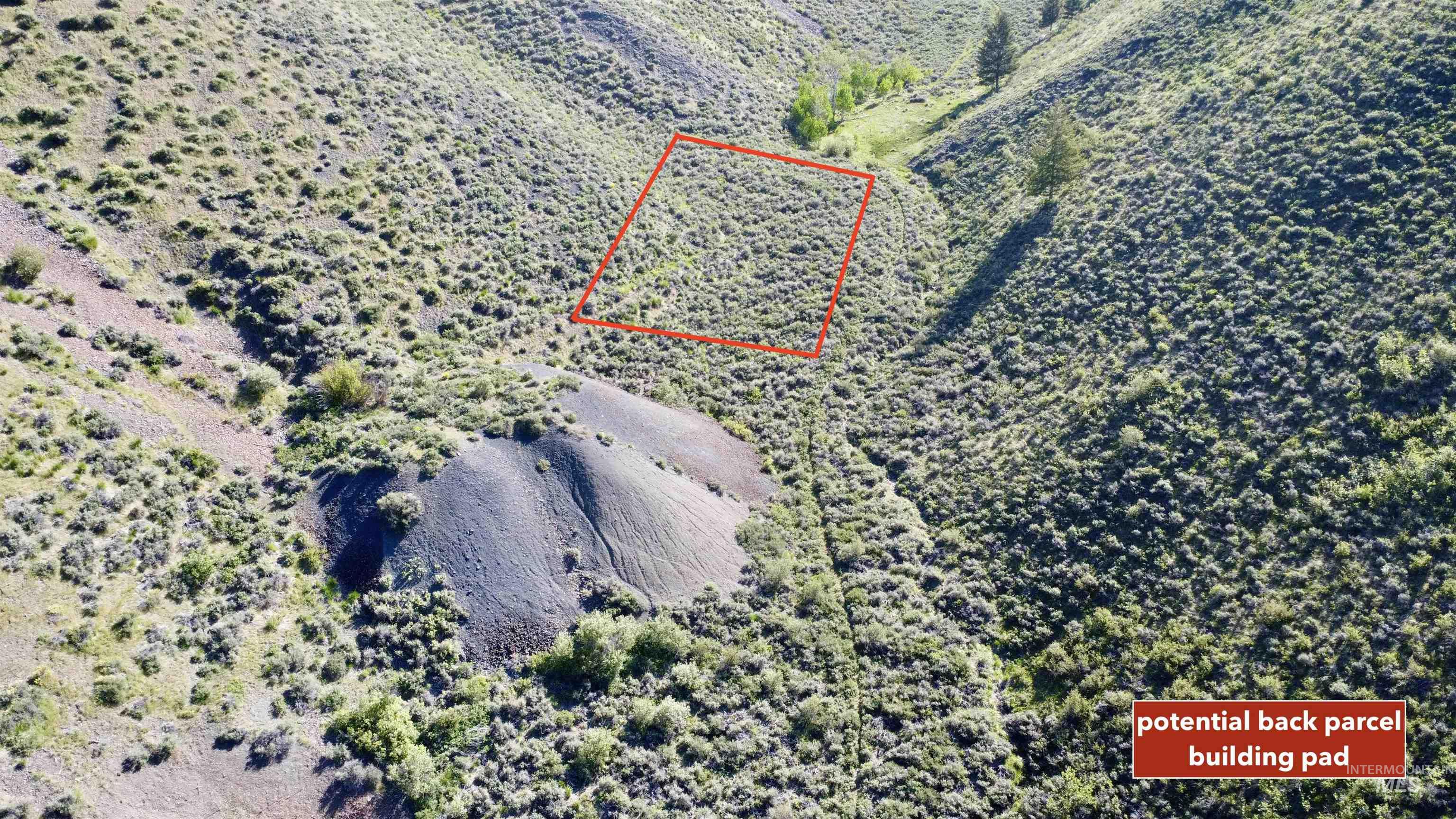 Aerial view of sparsely populated area featuring property parcel outlined