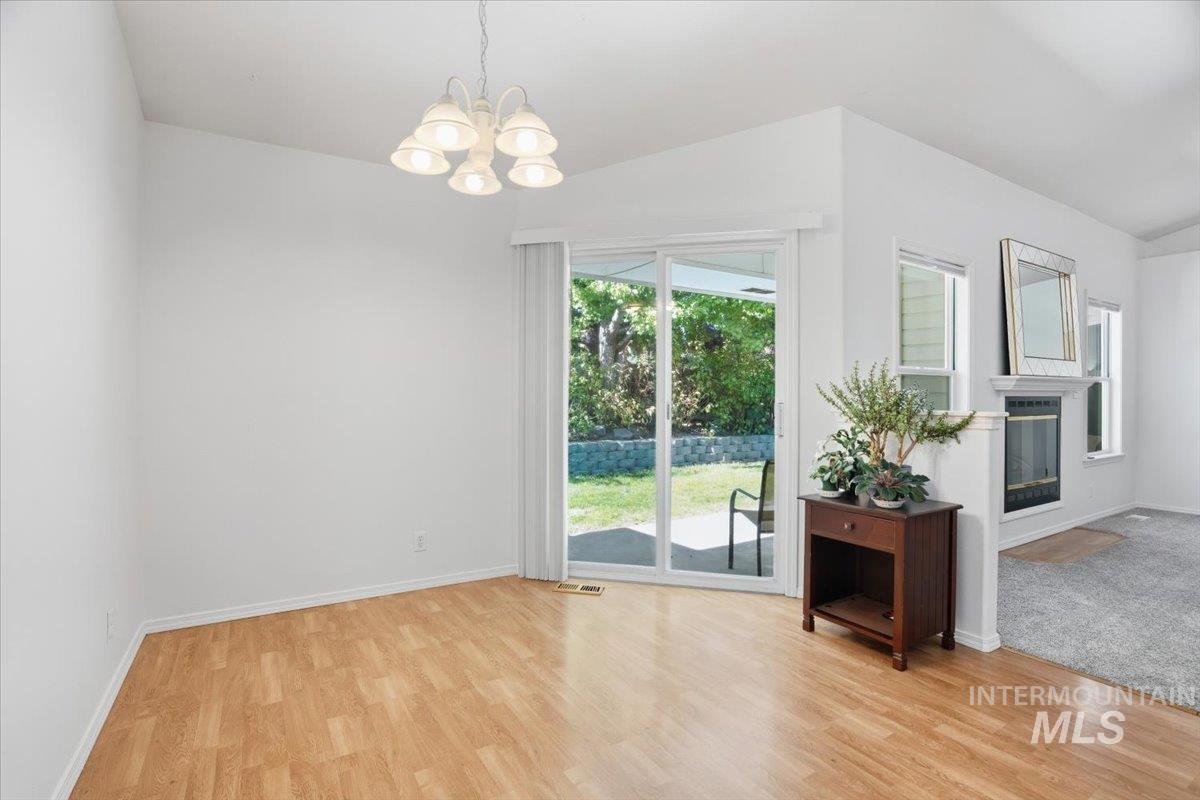 Unfurnished dining area with a chandelier and backyard/patio access