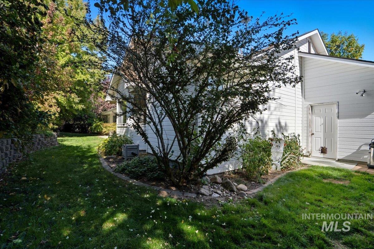 View of side of home featuring a yard