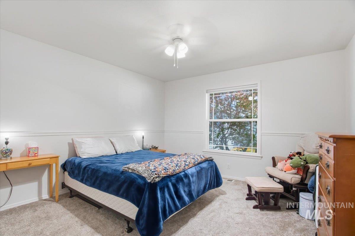 Bedroom with carpet floors and ceiling fan