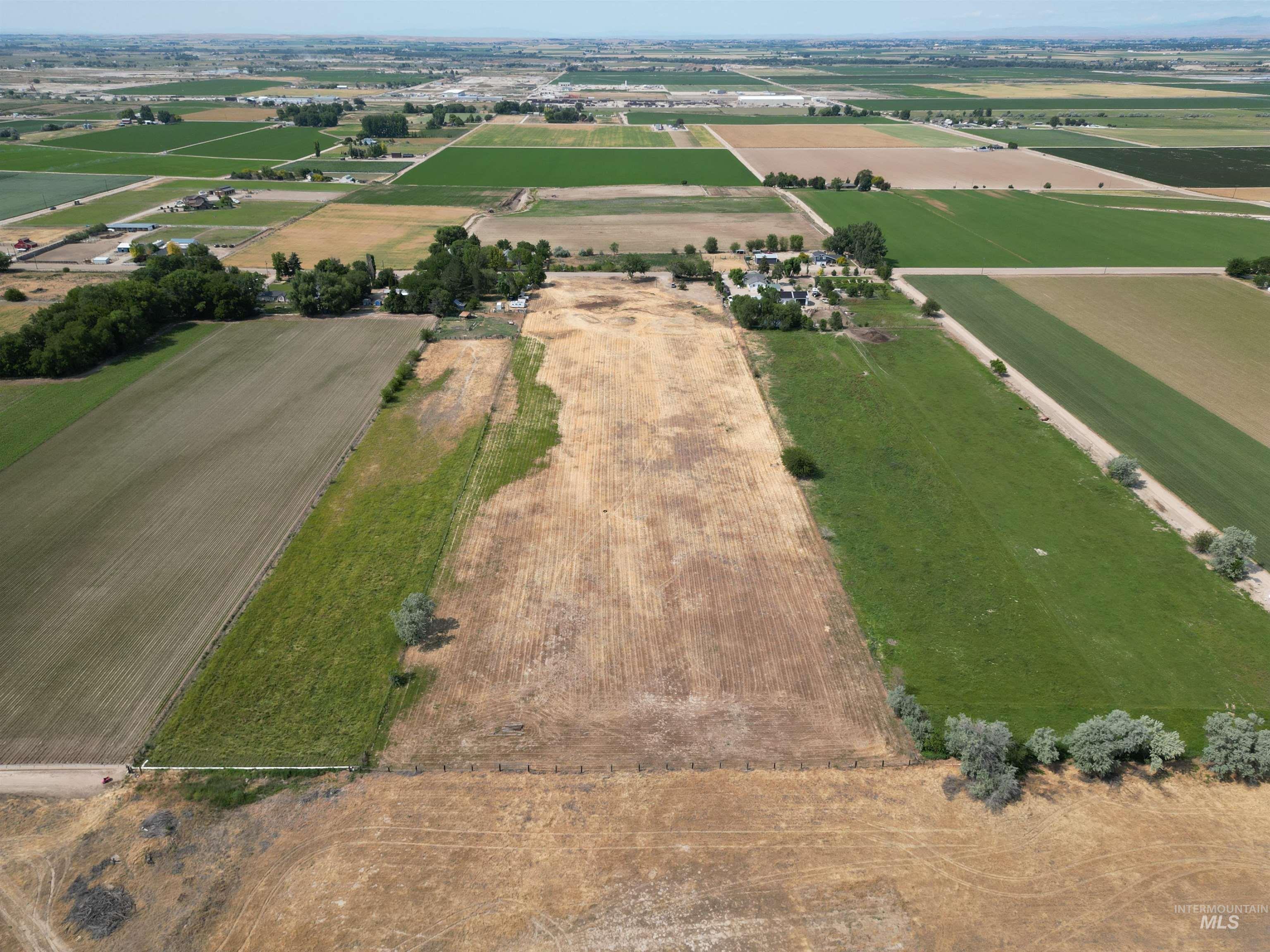 Aerial view of property's location with rural landscape and extensive farmland
