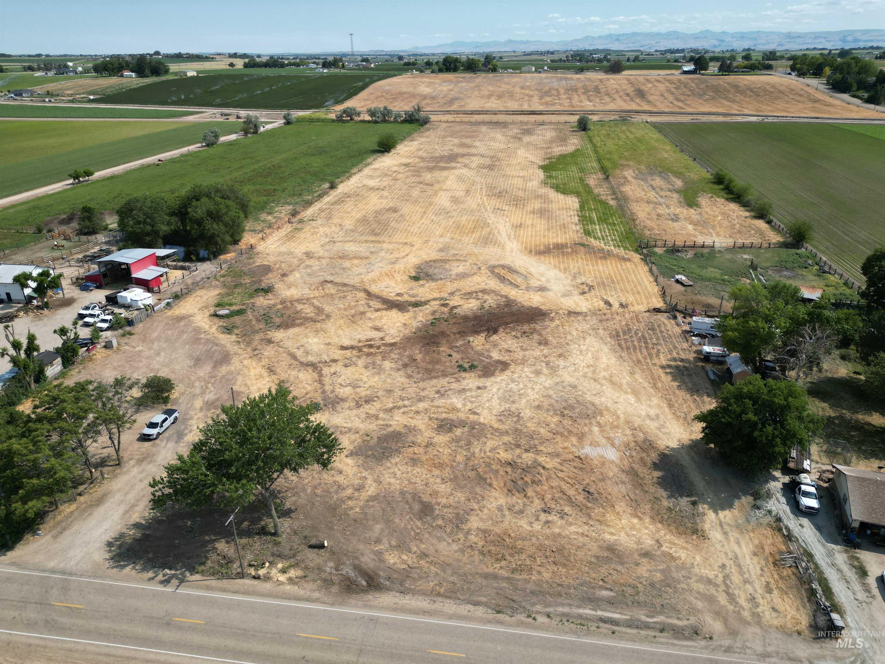 Aerial view of property's location featuring rural landscape and farmland