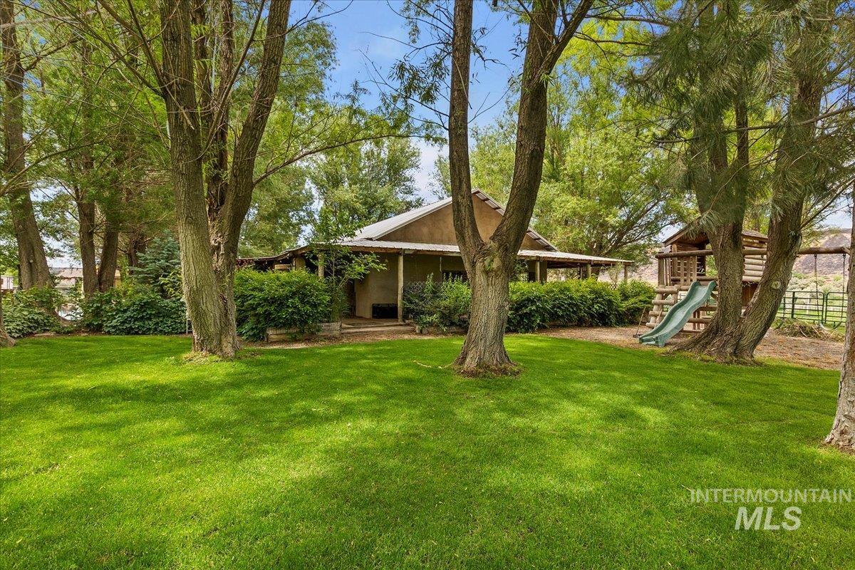 View of grassy yard featuring a playground