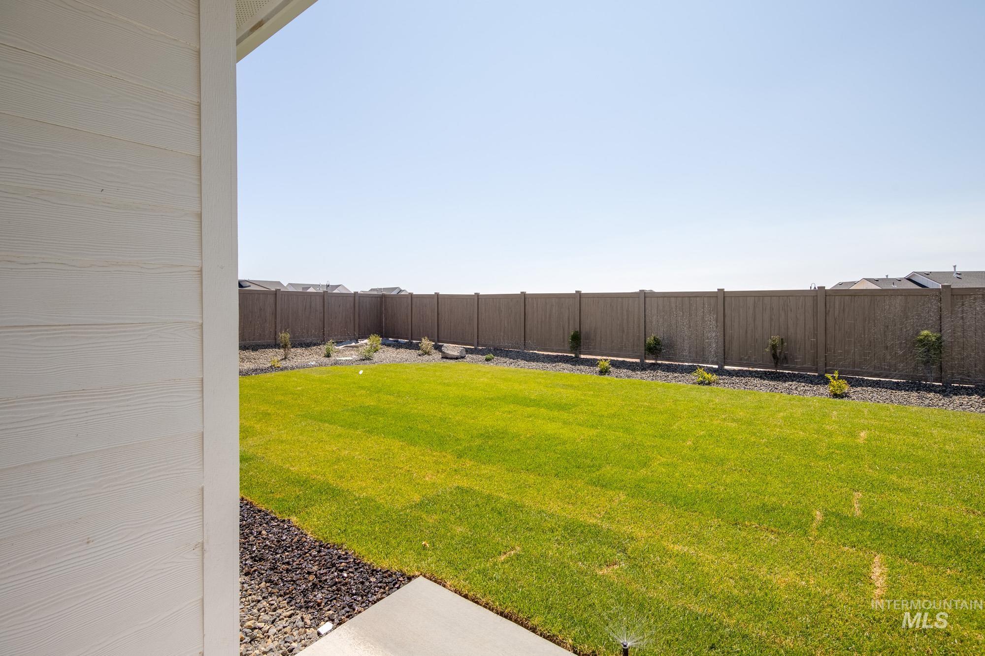 View of fenced backyard