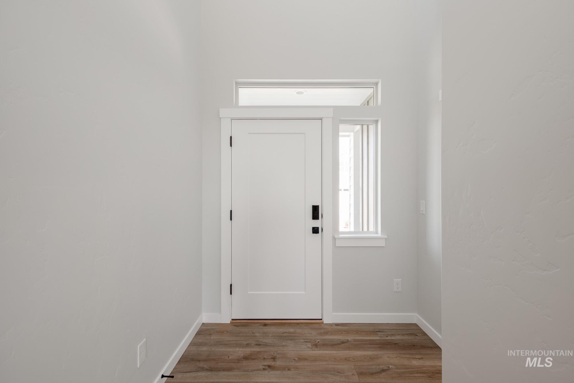 Foyer featuring wood finished floors and baseboards