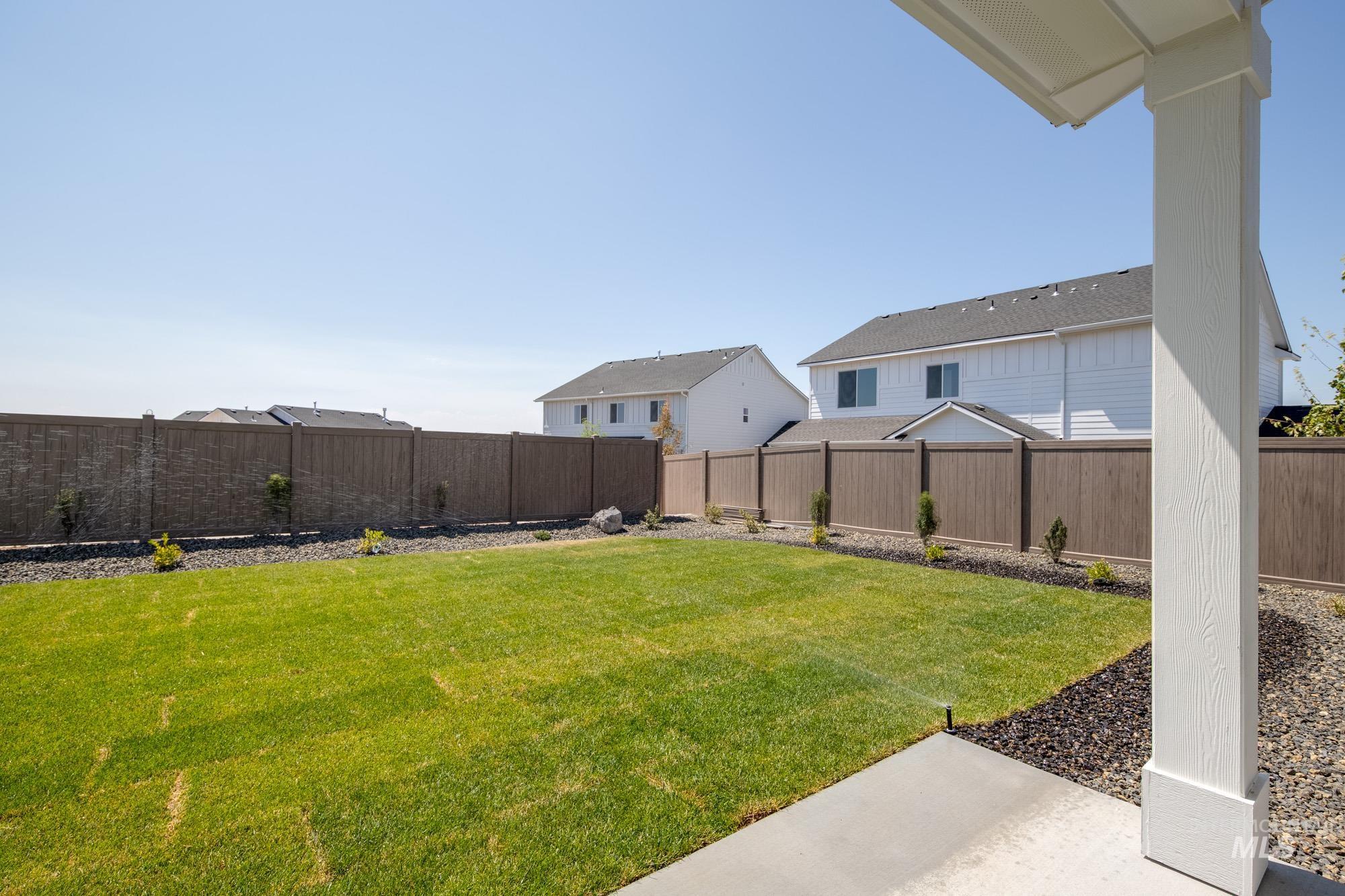 Fenced backyard featuring a residential view