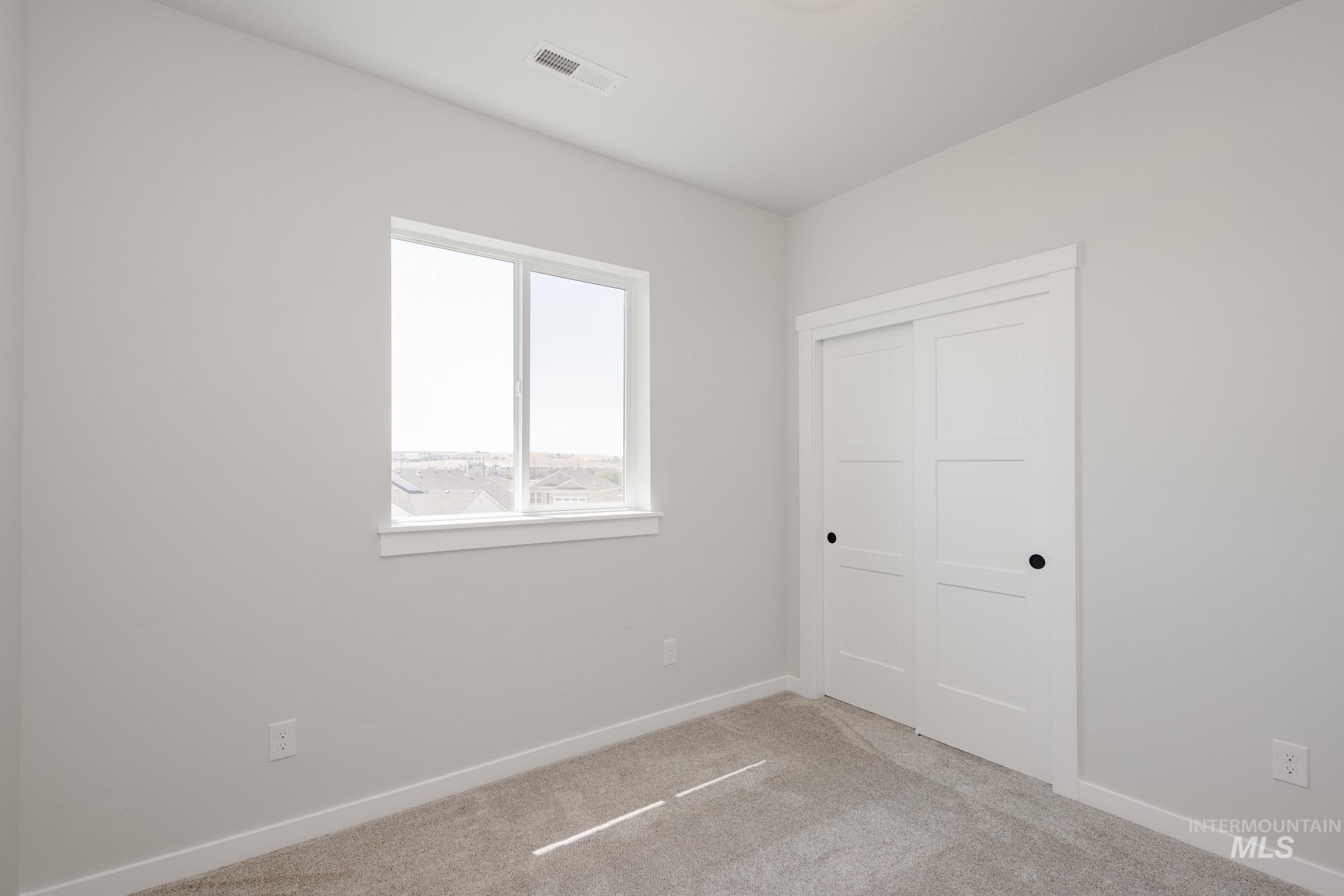 Unfurnished bedroom with carpet flooring and a closet