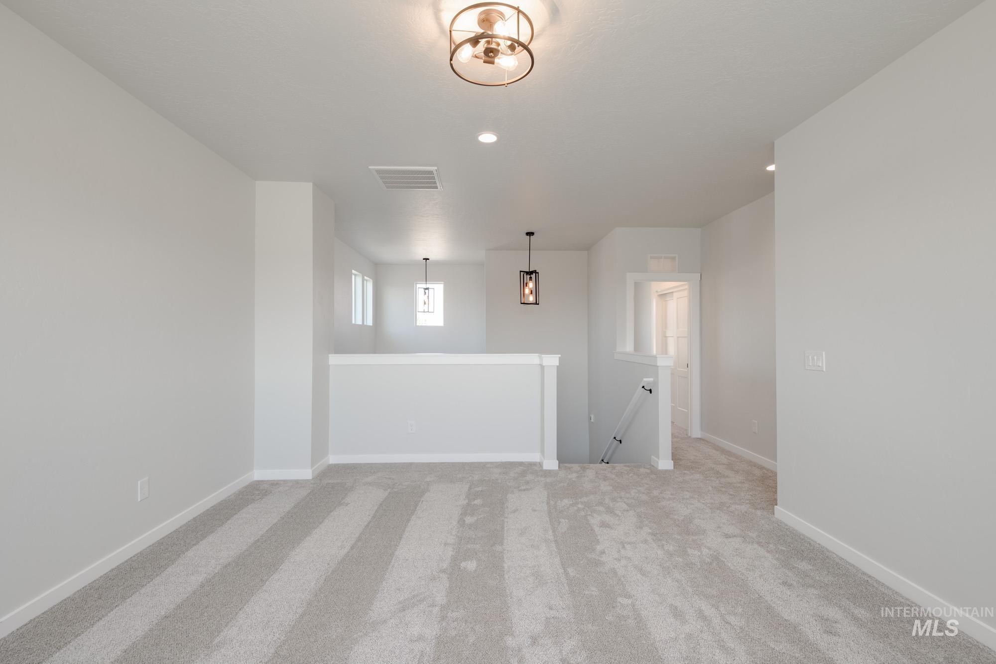 Empty room featuring light carpet and recessed lighting