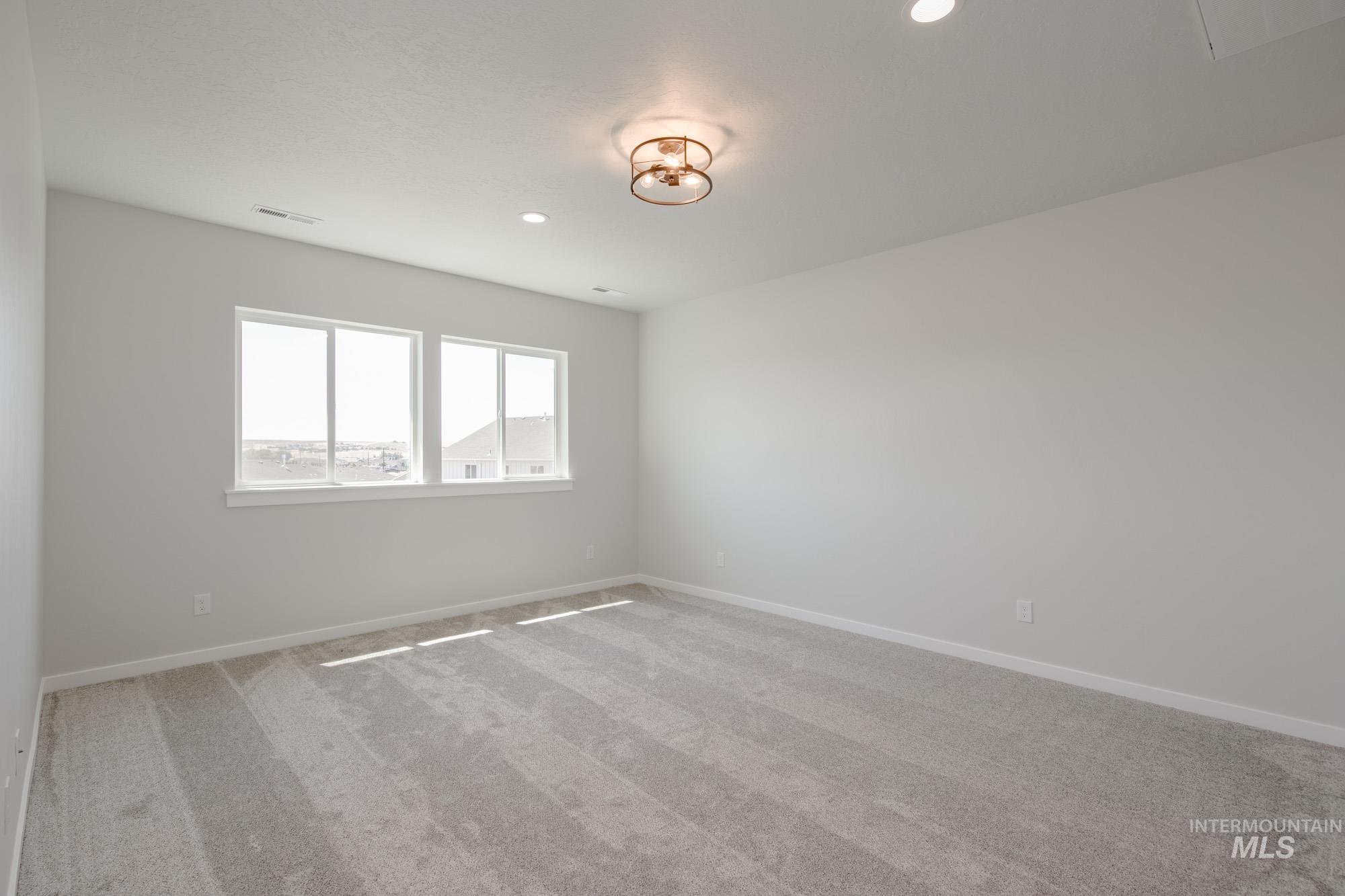 Spare room with carpet and recessed lighting