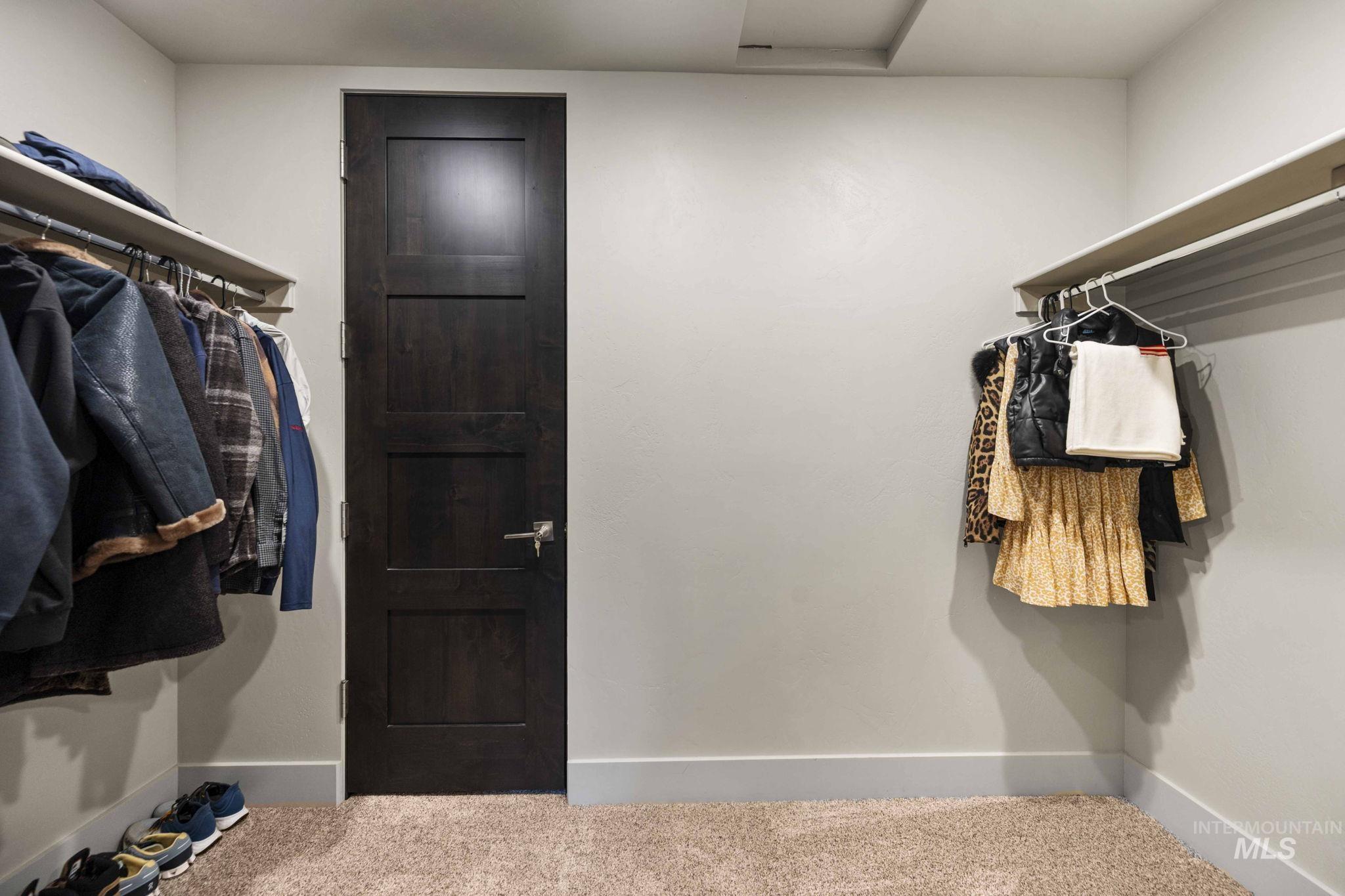 Spacious closet featuring carpet flooring and attic access