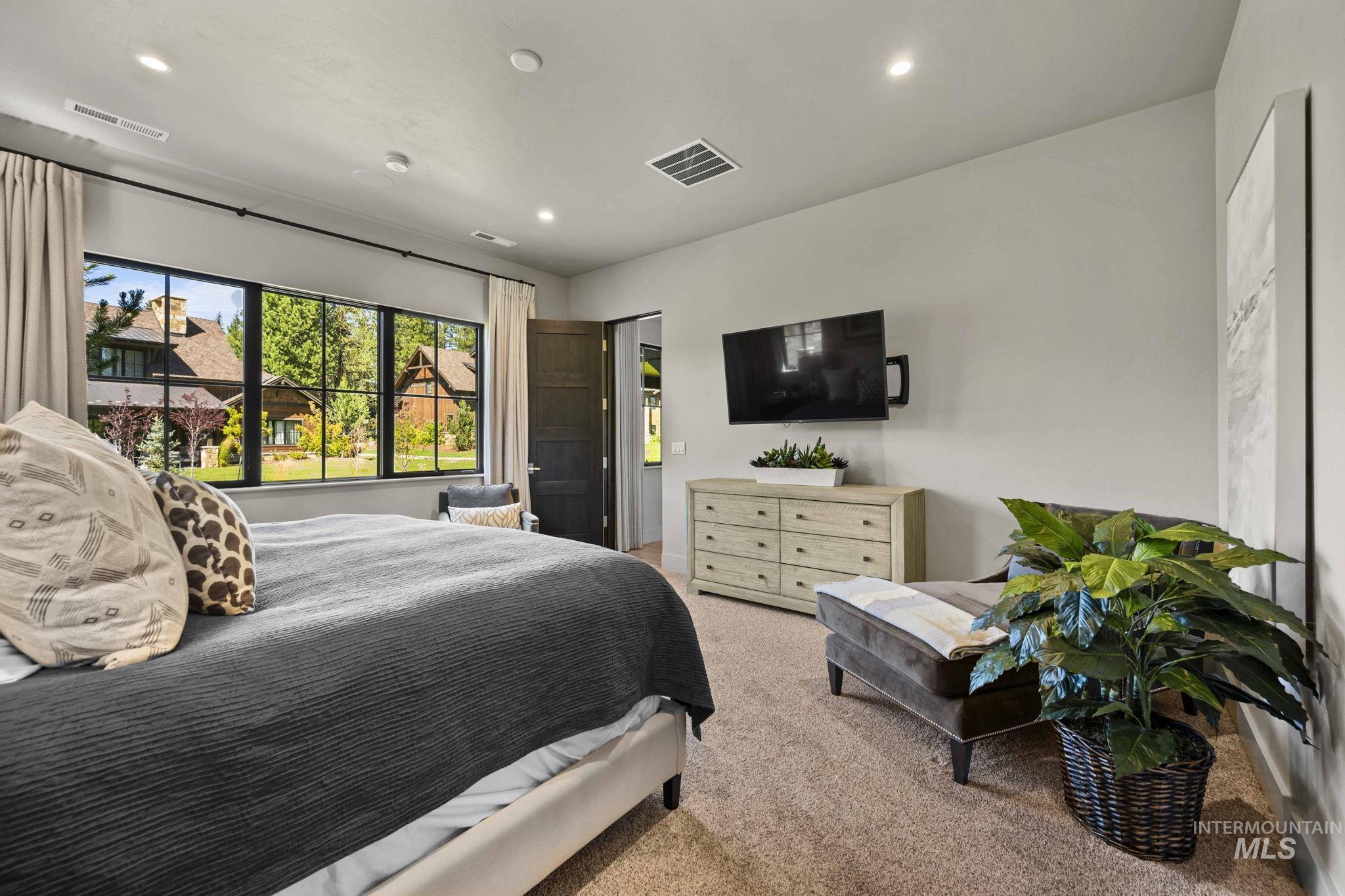 Bedroom with light carpet and recessed lighting