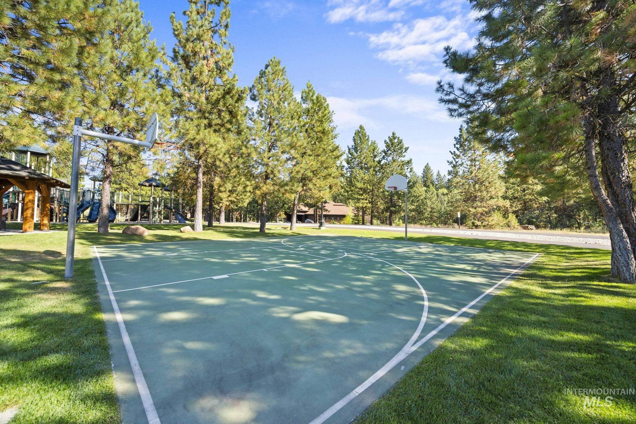 View of sport court with community basketball court, a lawn, and a gazebo