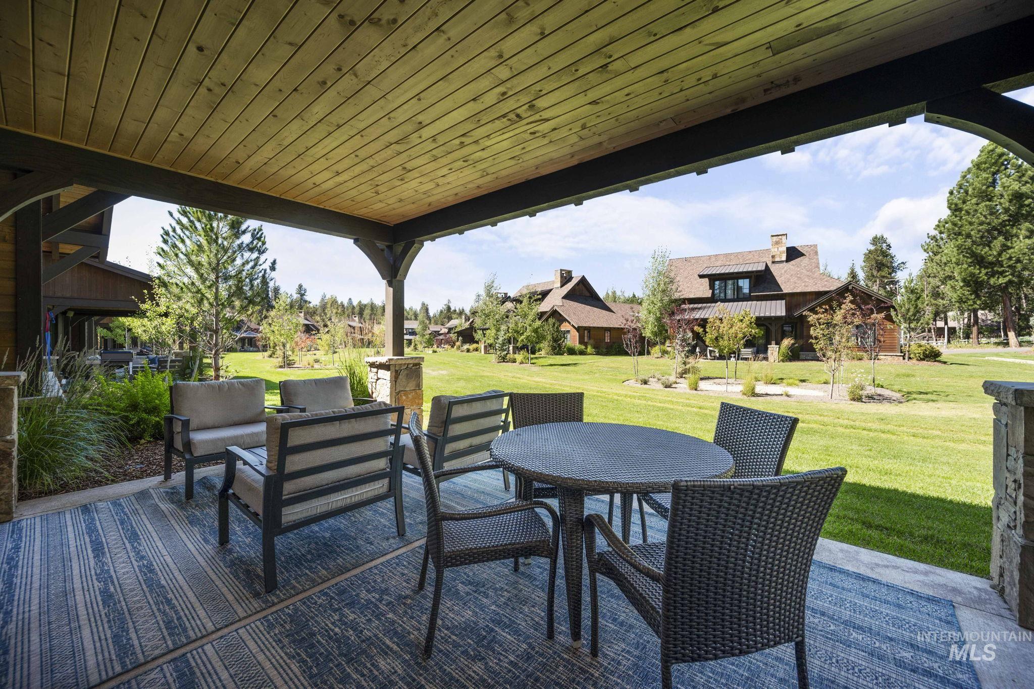 Wooden deck with a patio area, a yard, and outdoor dining area
