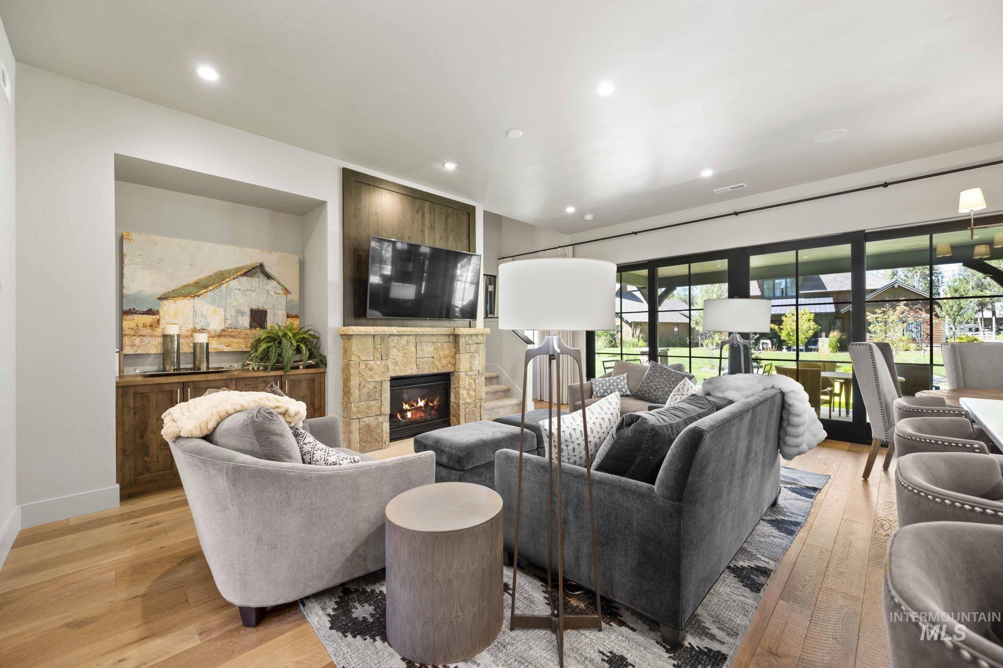 Living area featuring recessed lighting, light wood finished floors, and a tile fireplace
