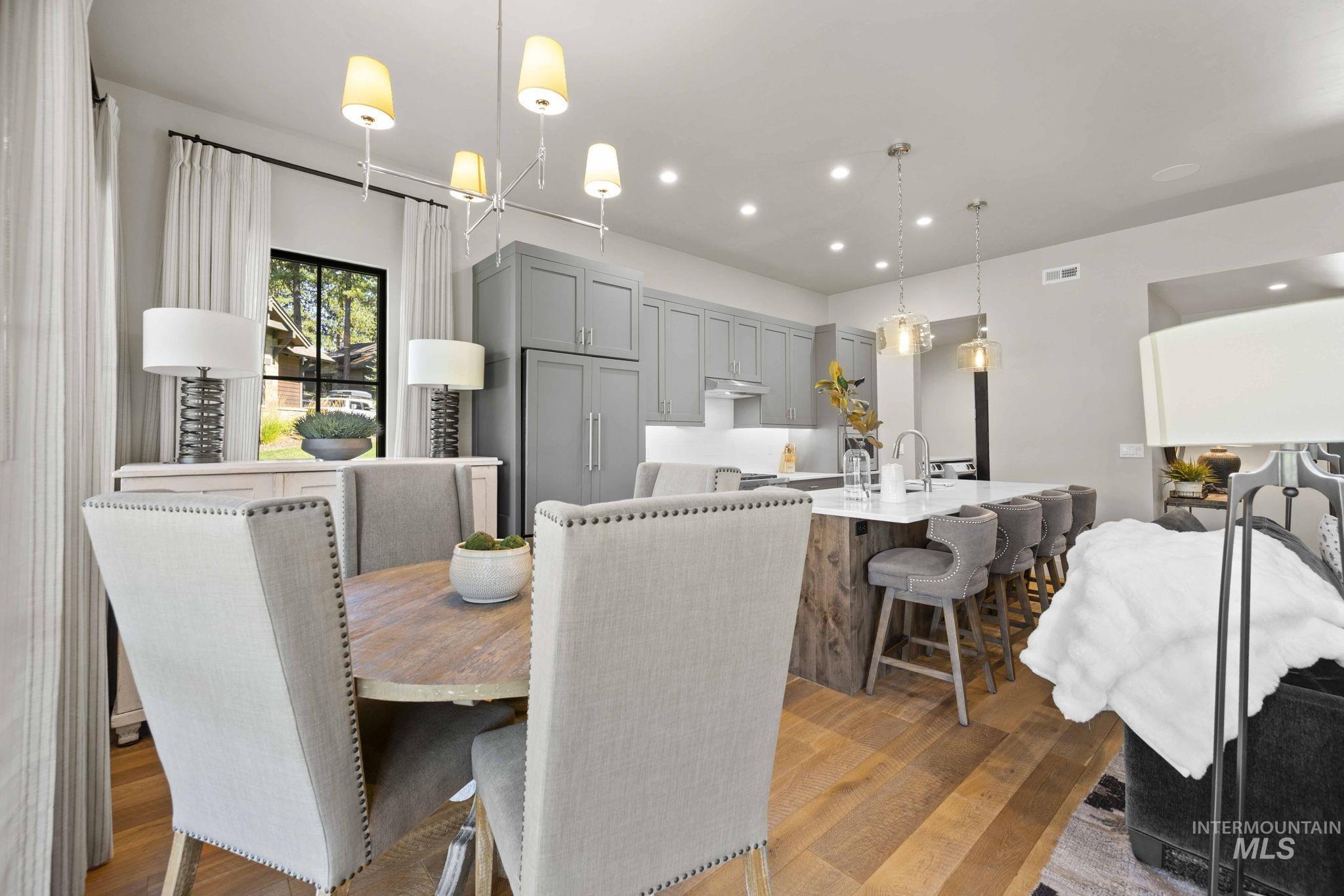 Dining area with recessed lighting and dark wood-style flooring
