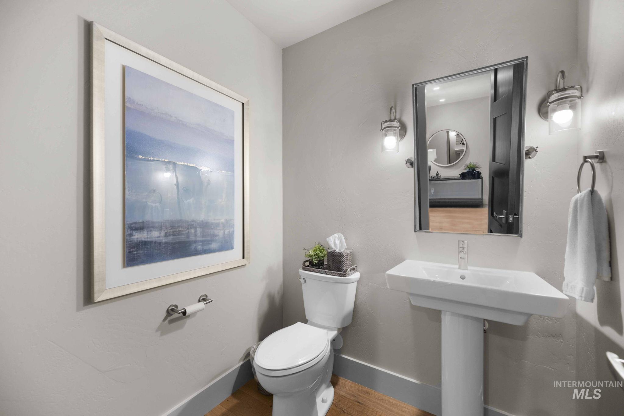 Bathroom featuring baseboards and wood finished floors
