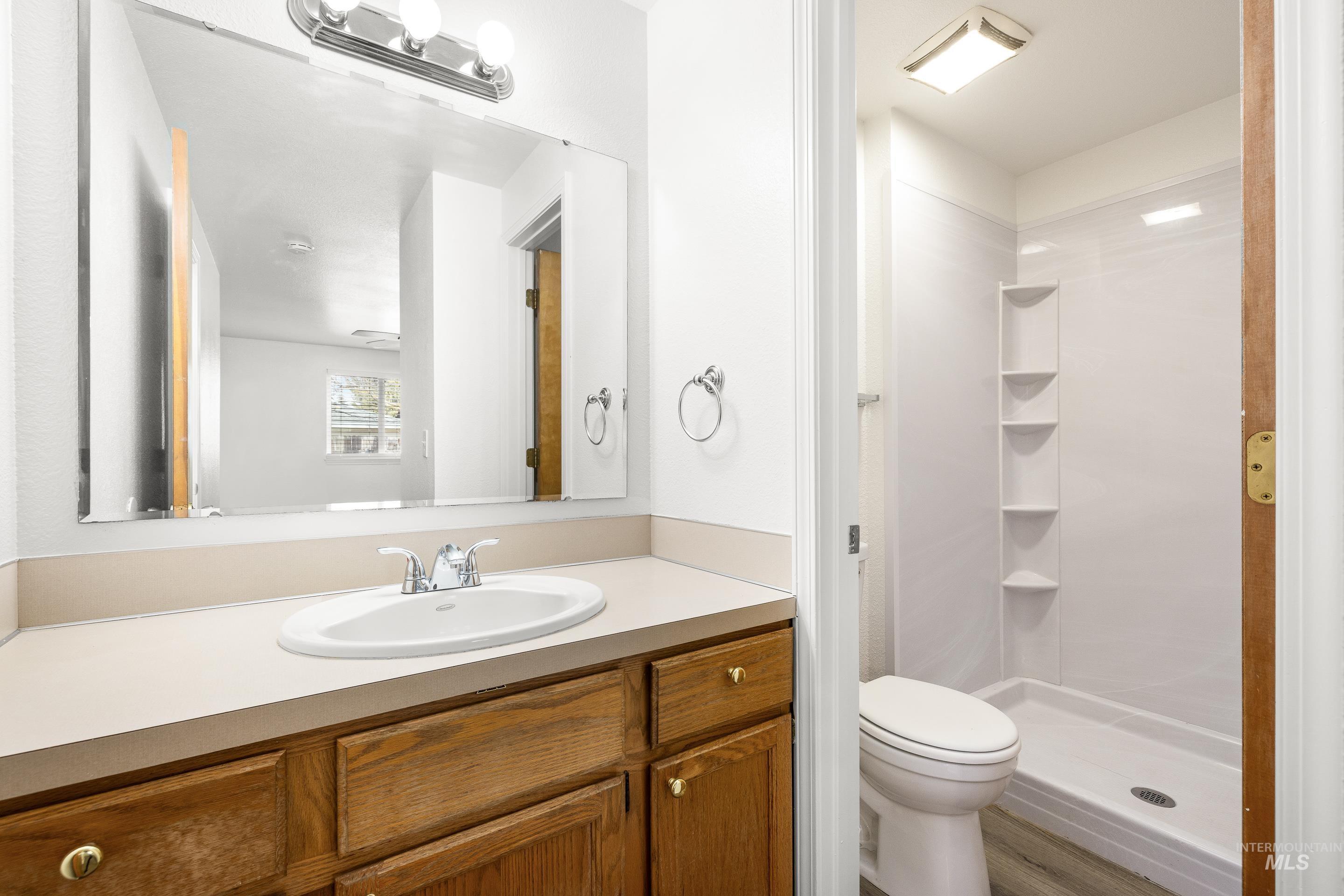 Full bathroom featuring vanity and a shower stall