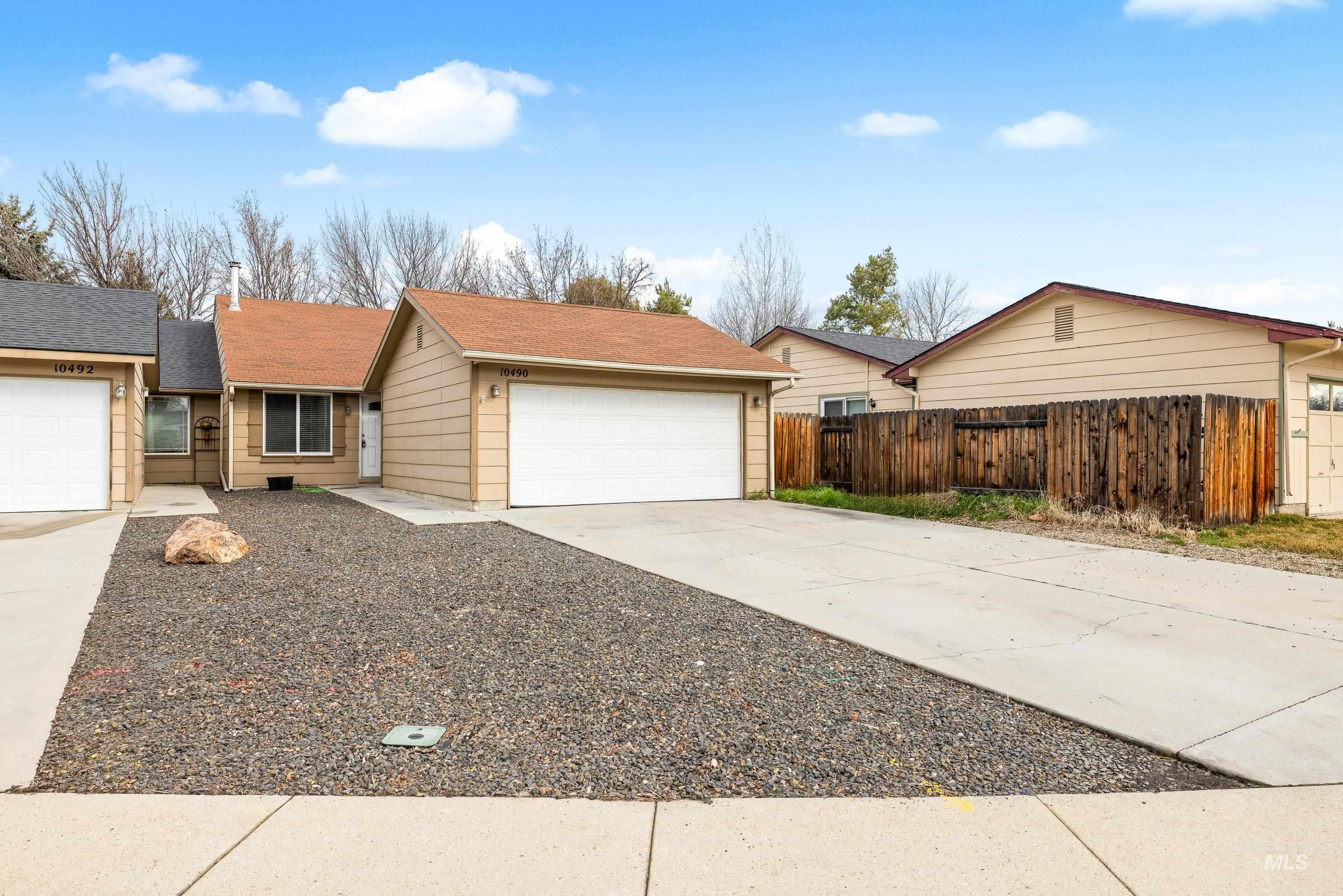 Single story home featuring concrete driveway and an attached garage
