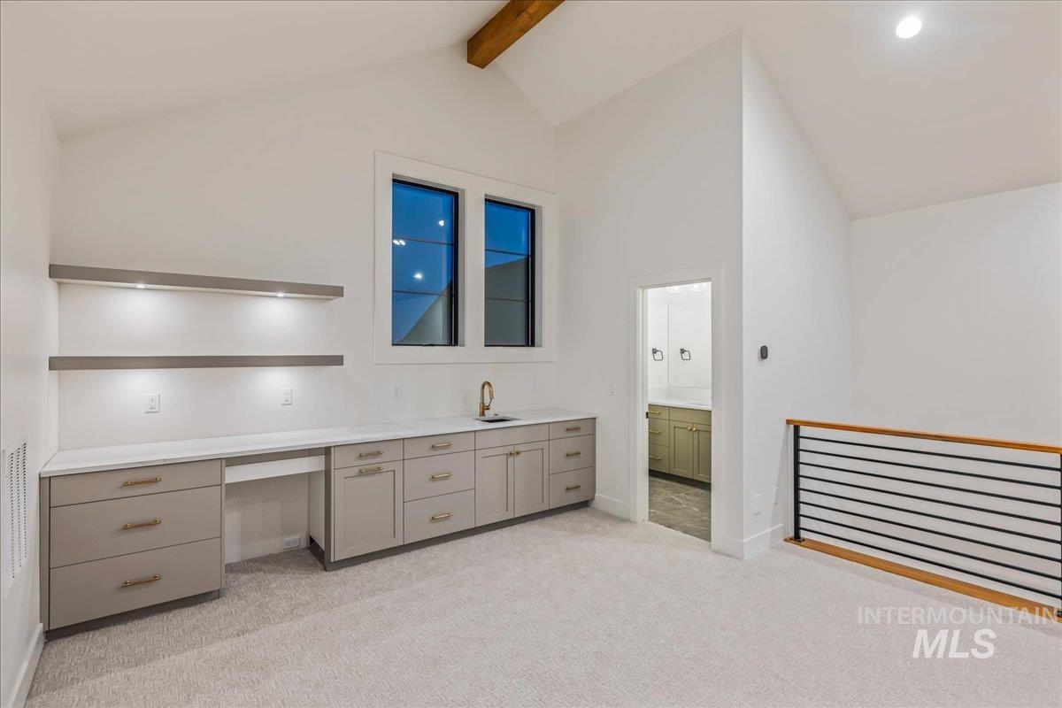 Full bathroom featuring vanity, light colored carpet, beam ceiling, and high vaulted ceiling