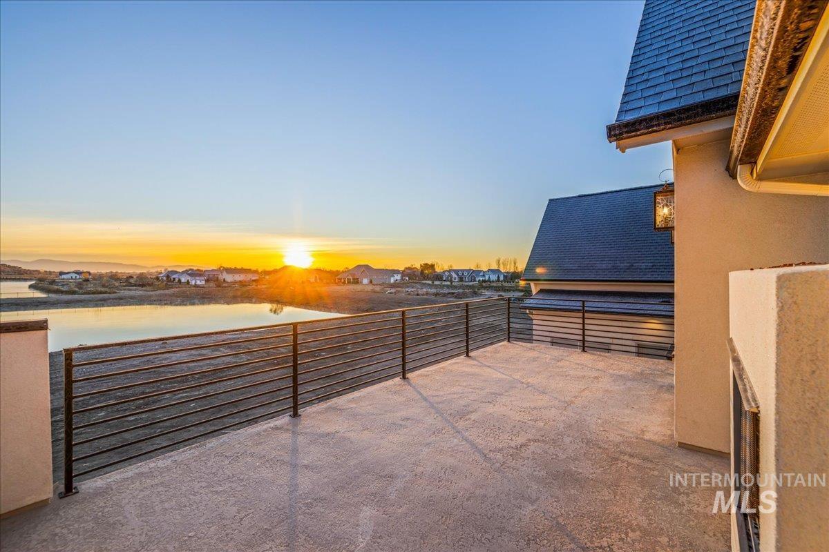 Patio terrace at dusk with a water view and a patio area