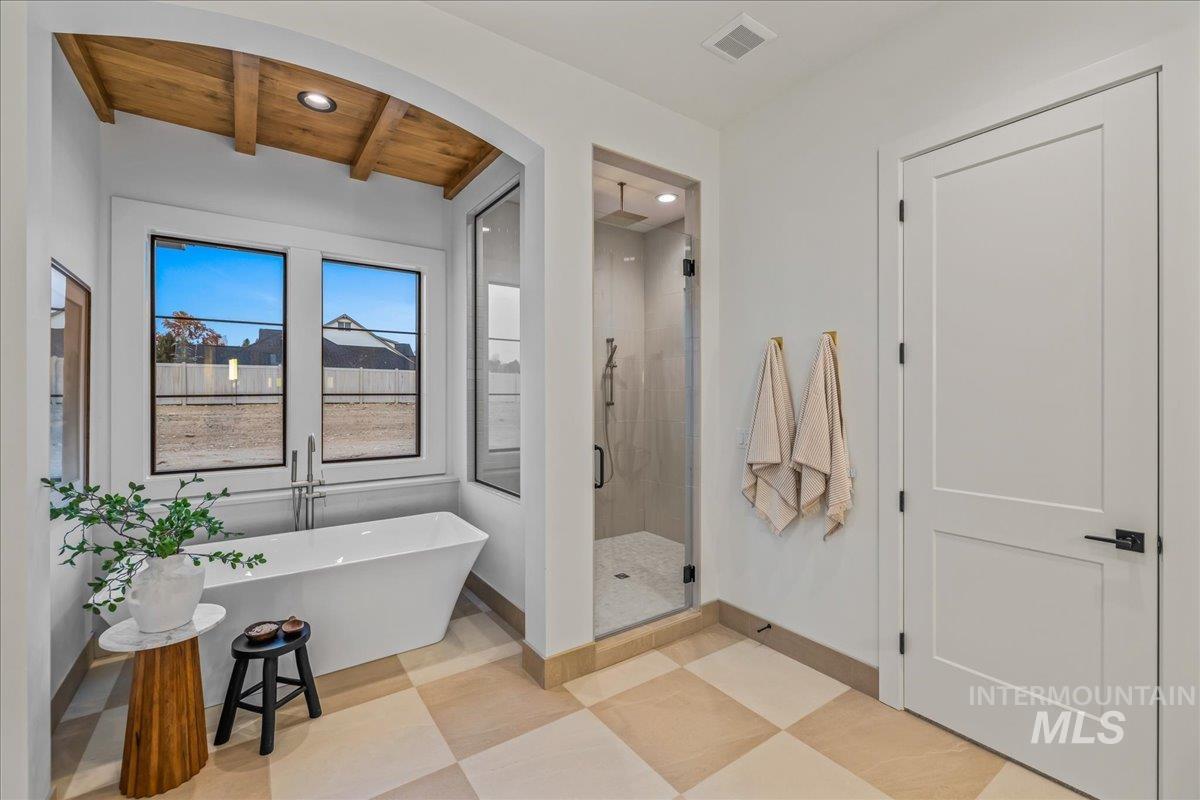 Full bath with a shower stall, light flooring, a soaking tub, a wood ceiling with exposed beams, and recessed lighting