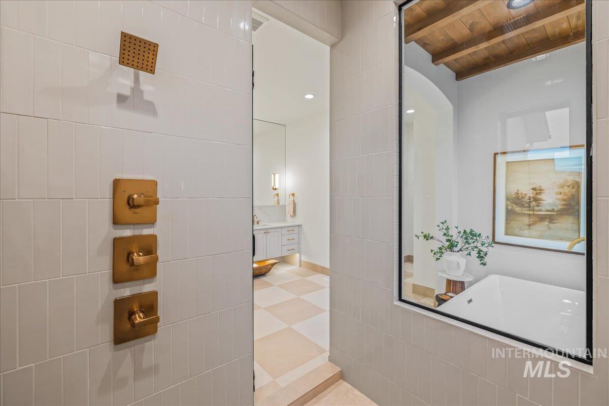Full bathroom featuring vanity, a wood ceiling with exposed beams, a freestanding bath, light tile patterned floors, and recessed lighting