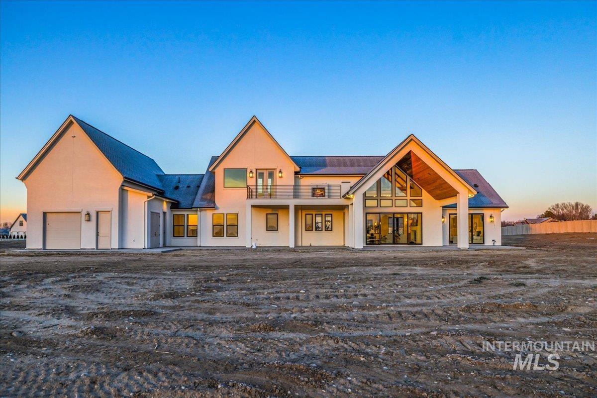 View of front of property with a patio area and stucco siding