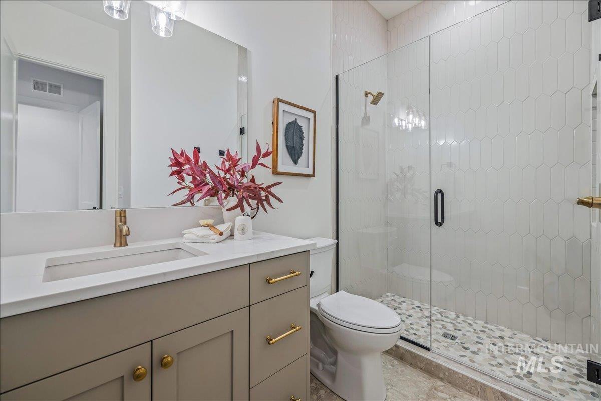 Full bathroom featuring vanity and a shower stall