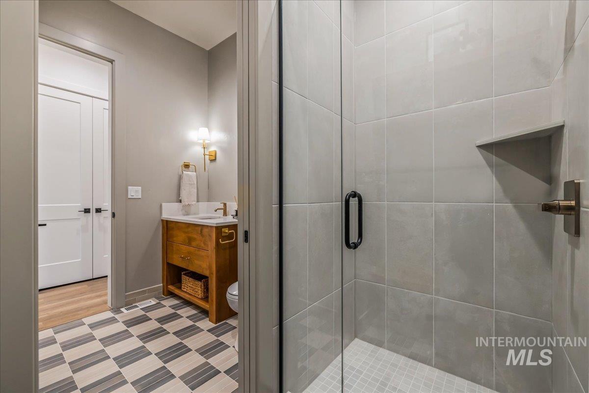 Bathroom with vanity and a stall shower