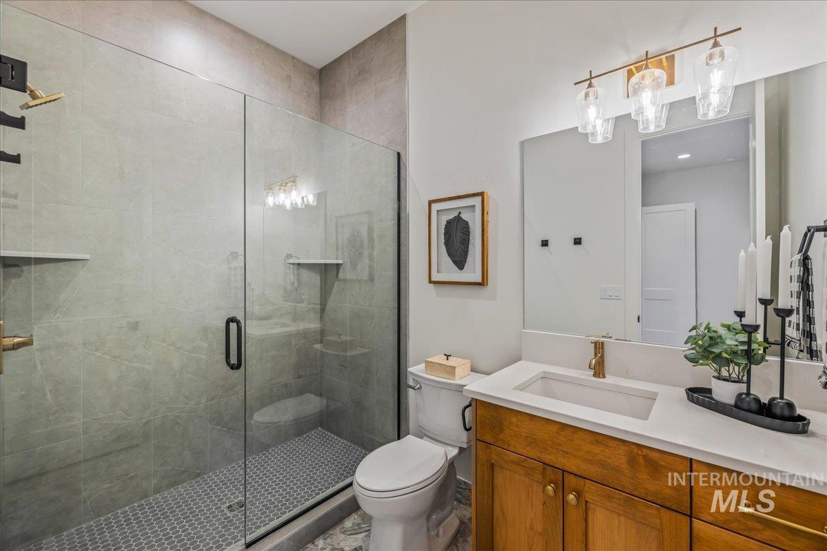 Full bath with vanity and a shower stall