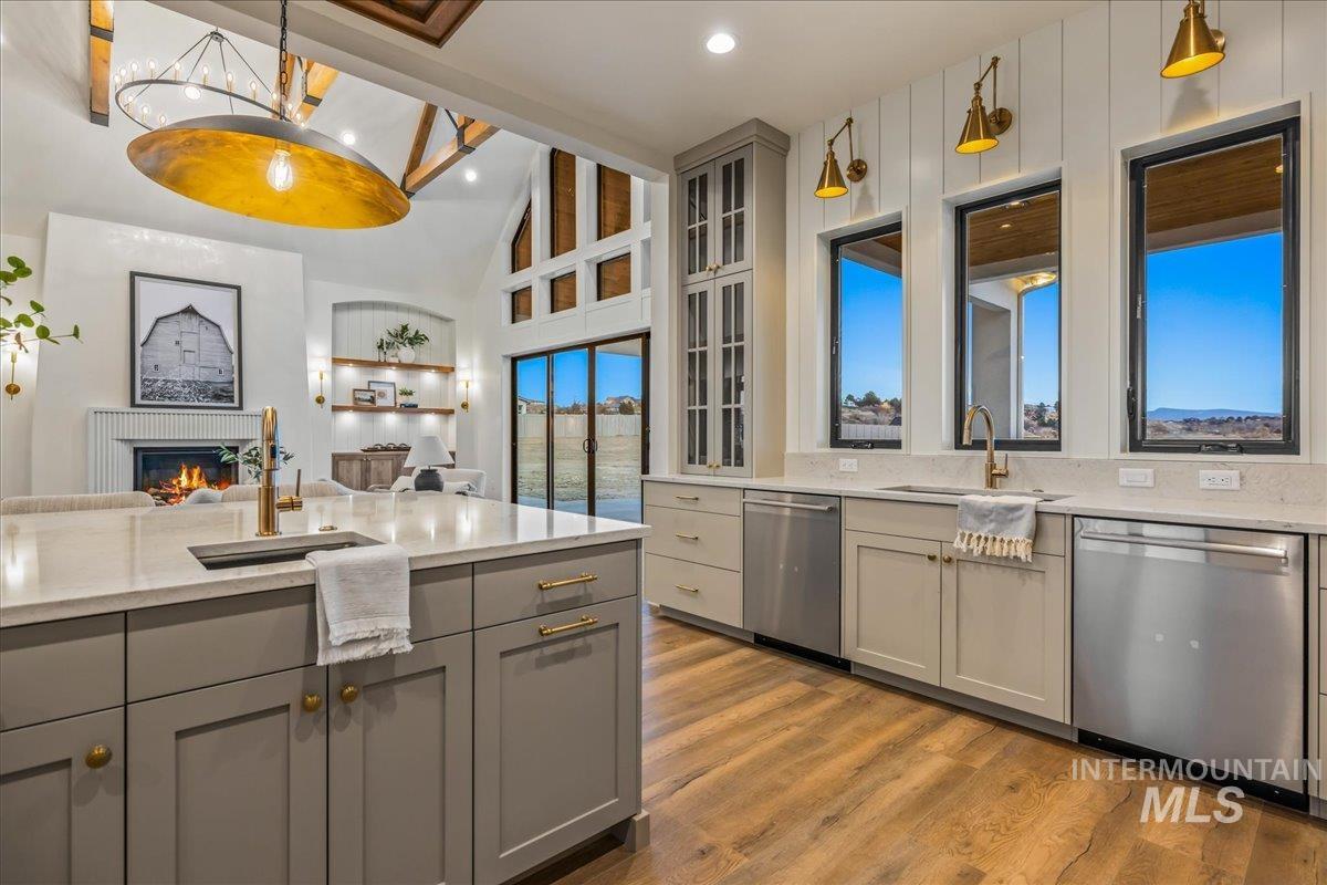 Kitchen with gray cabinets, pendant lighting, open floor plan, beamed ceiling, and recessed lighting