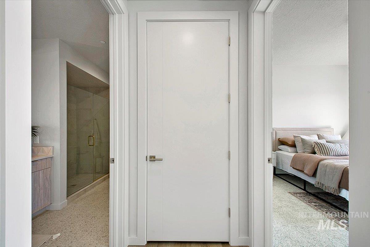 Hall featuring a textured ceiling and dark aggregate flooring