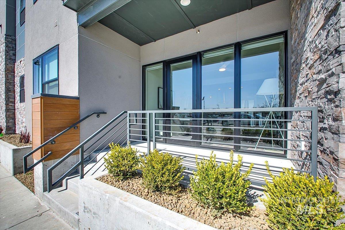 Entrance to property with stucco siding