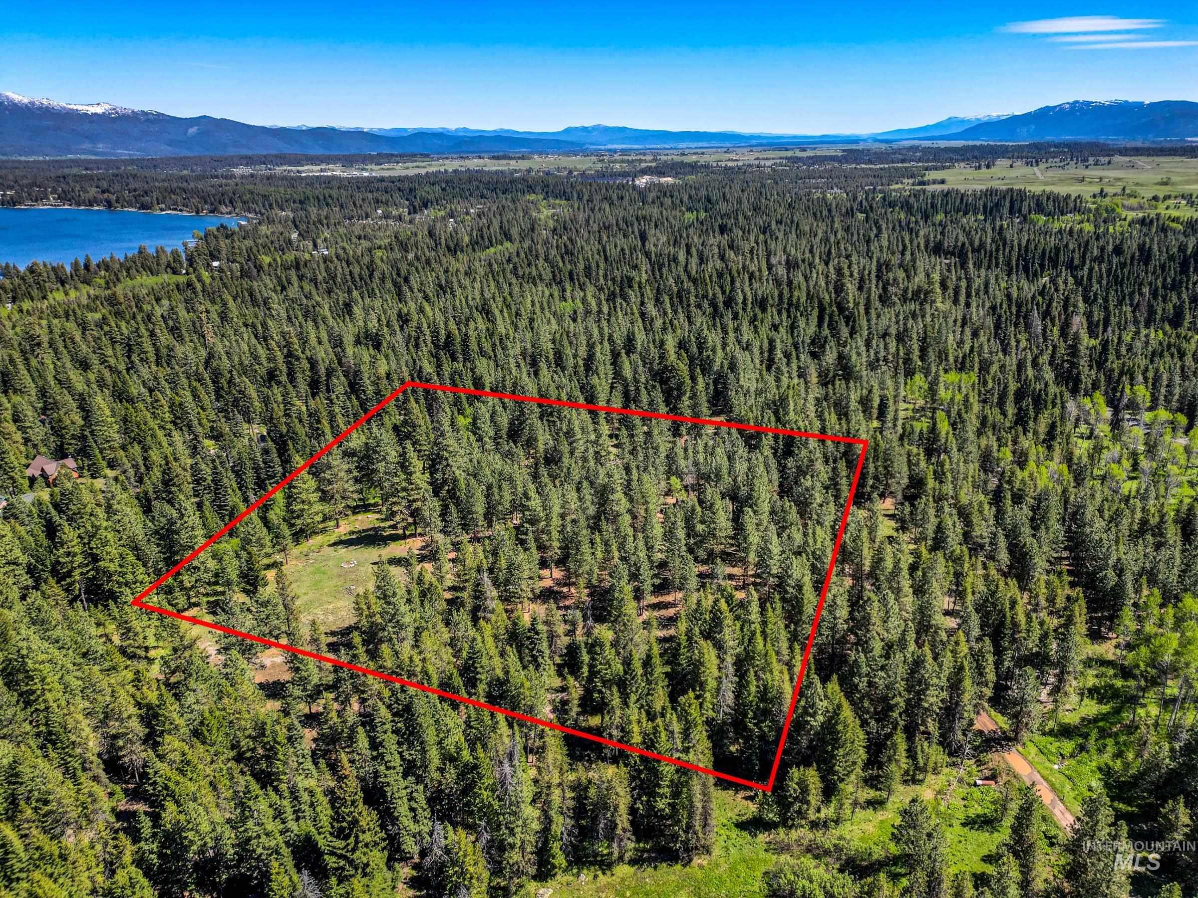 Aerial view of property's location with property parcel outlined and a water and mountain view