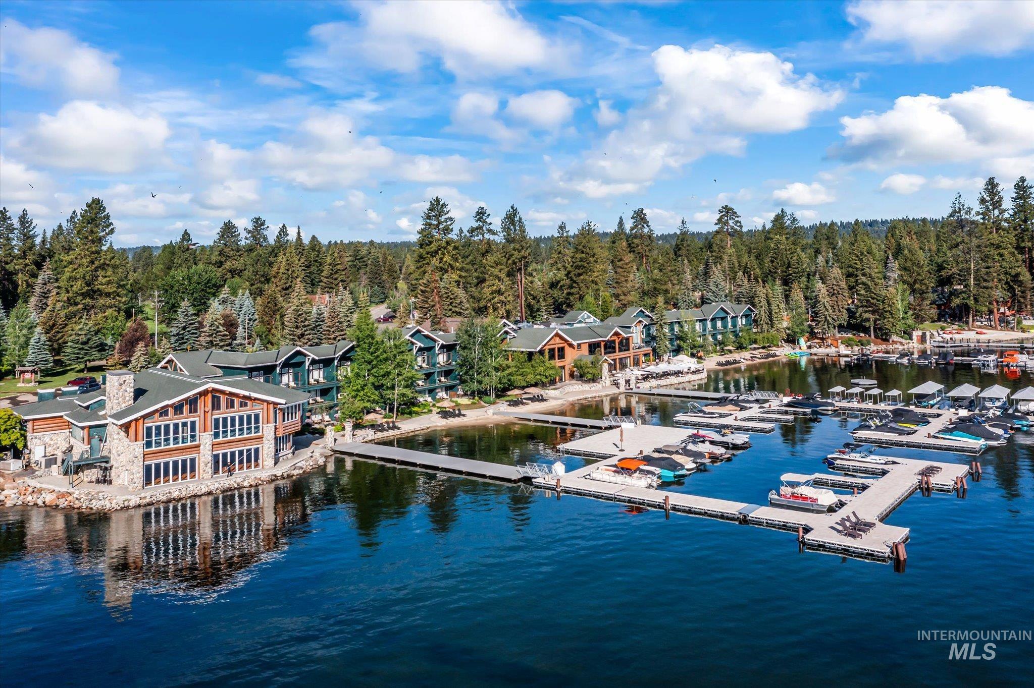 Dock with a wooded view and a water view