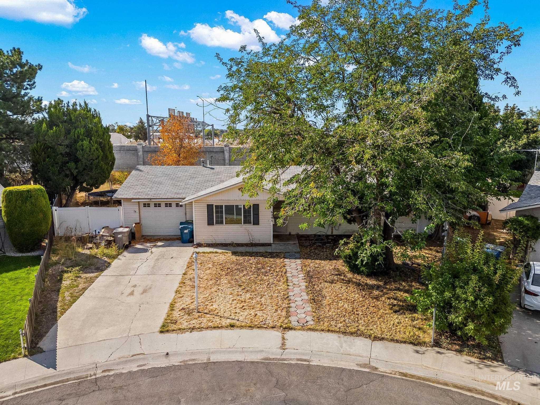 View of front of home with concrete driveway and an attached garage