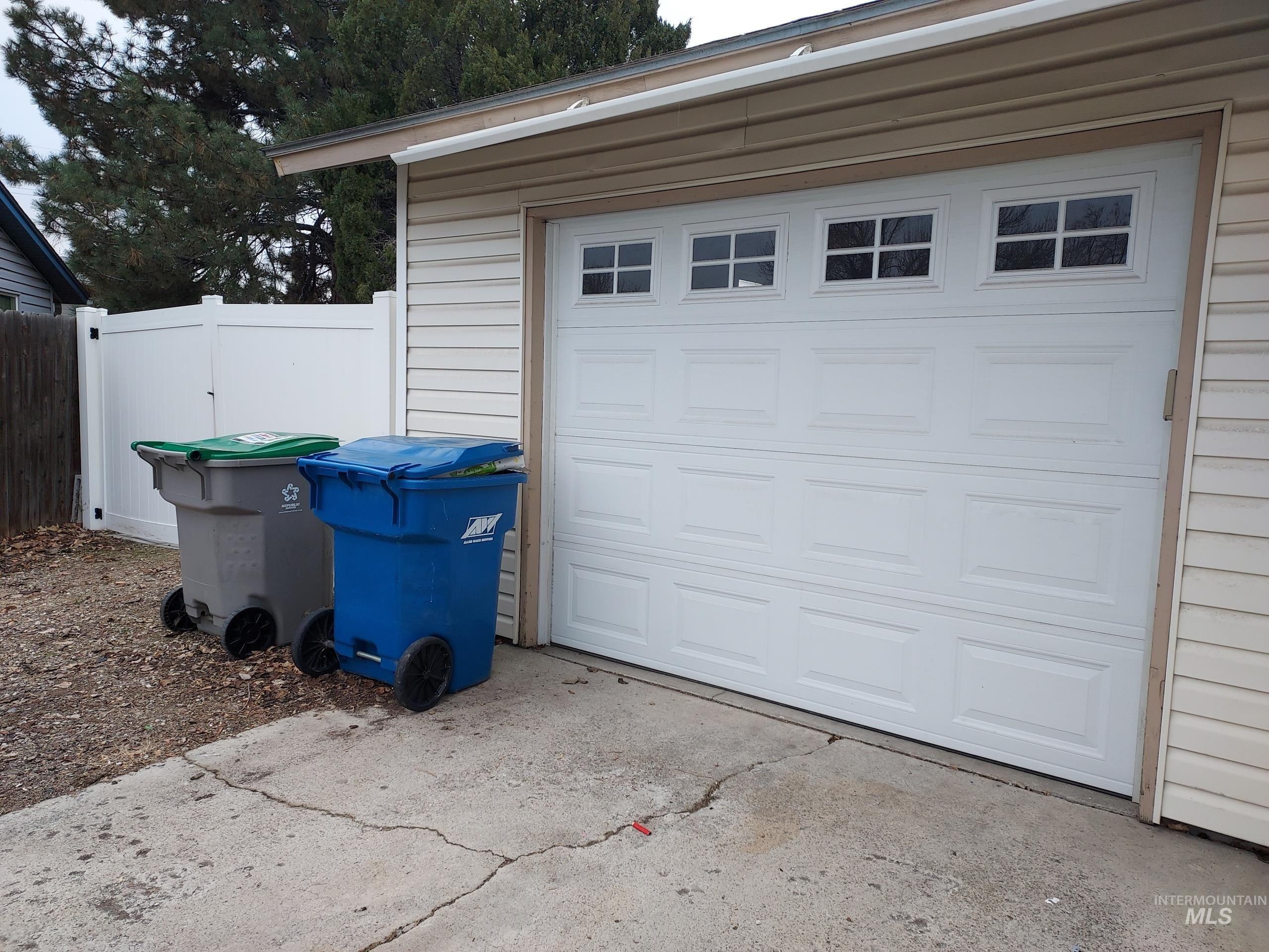 Garage featuring concrete driveway