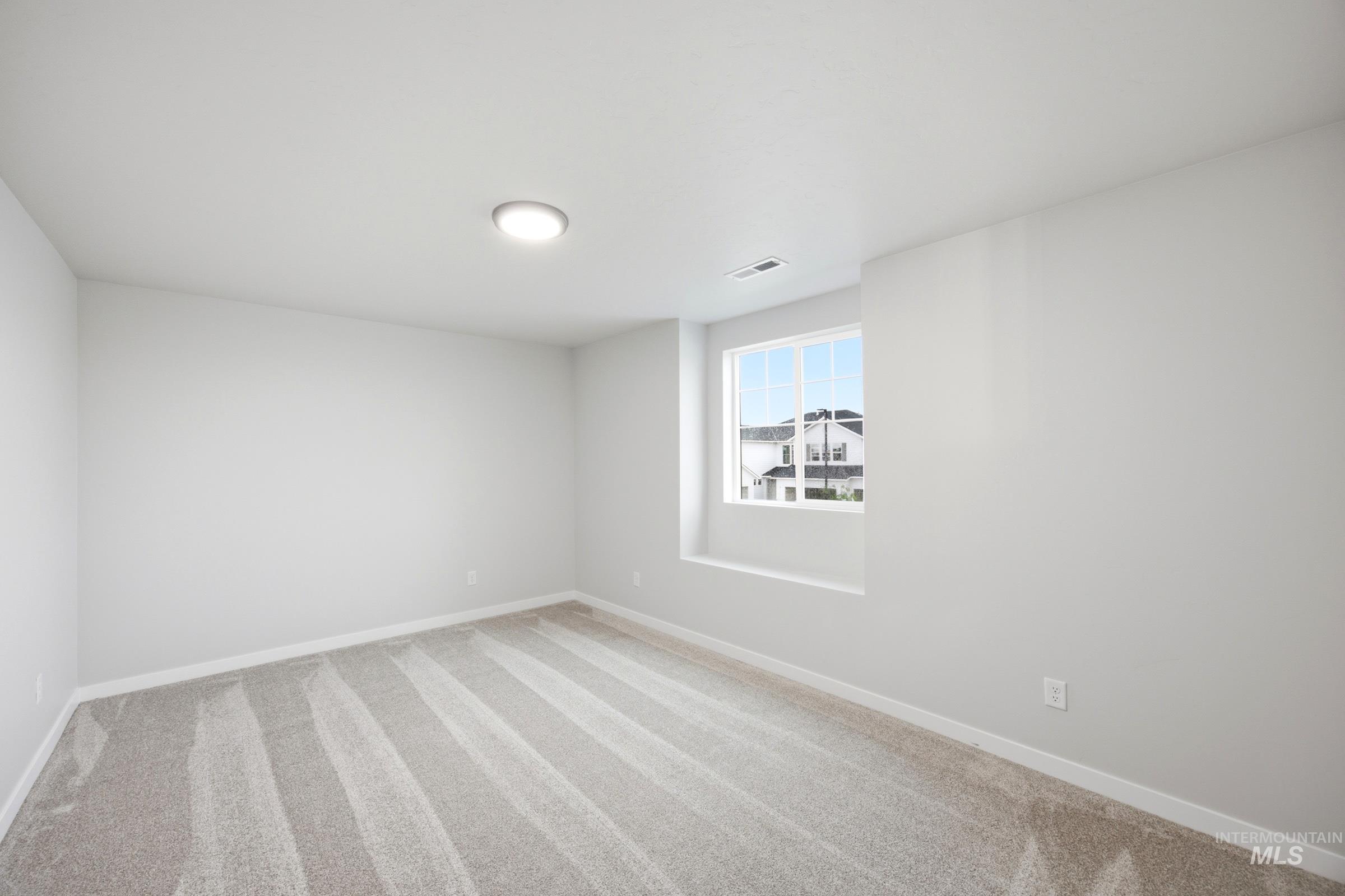 Neutral-toned carpeting and light gray walls create a versatile interior space