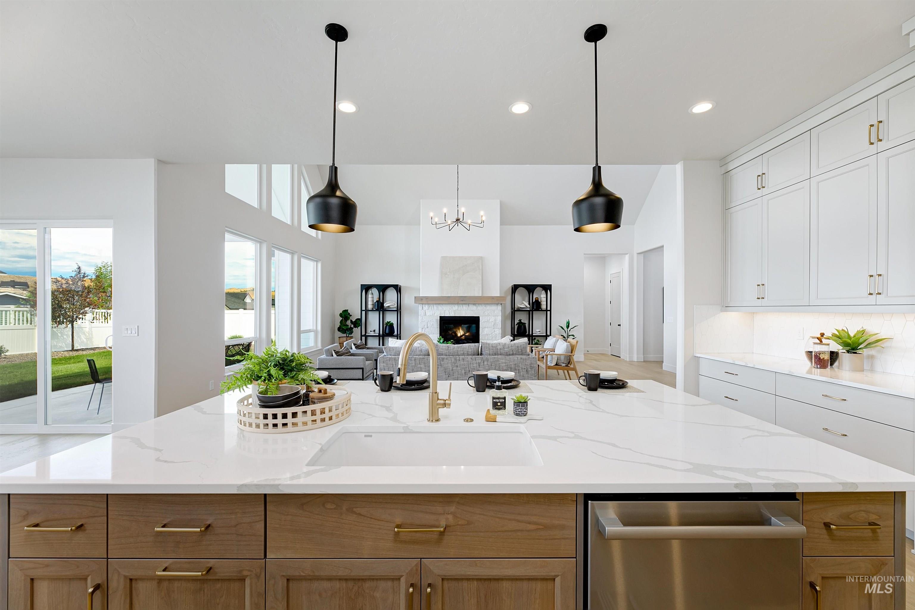 Kitchen featuring open floor plan, a center island with sink, dishwasher, a chandelier, and recessed lighting