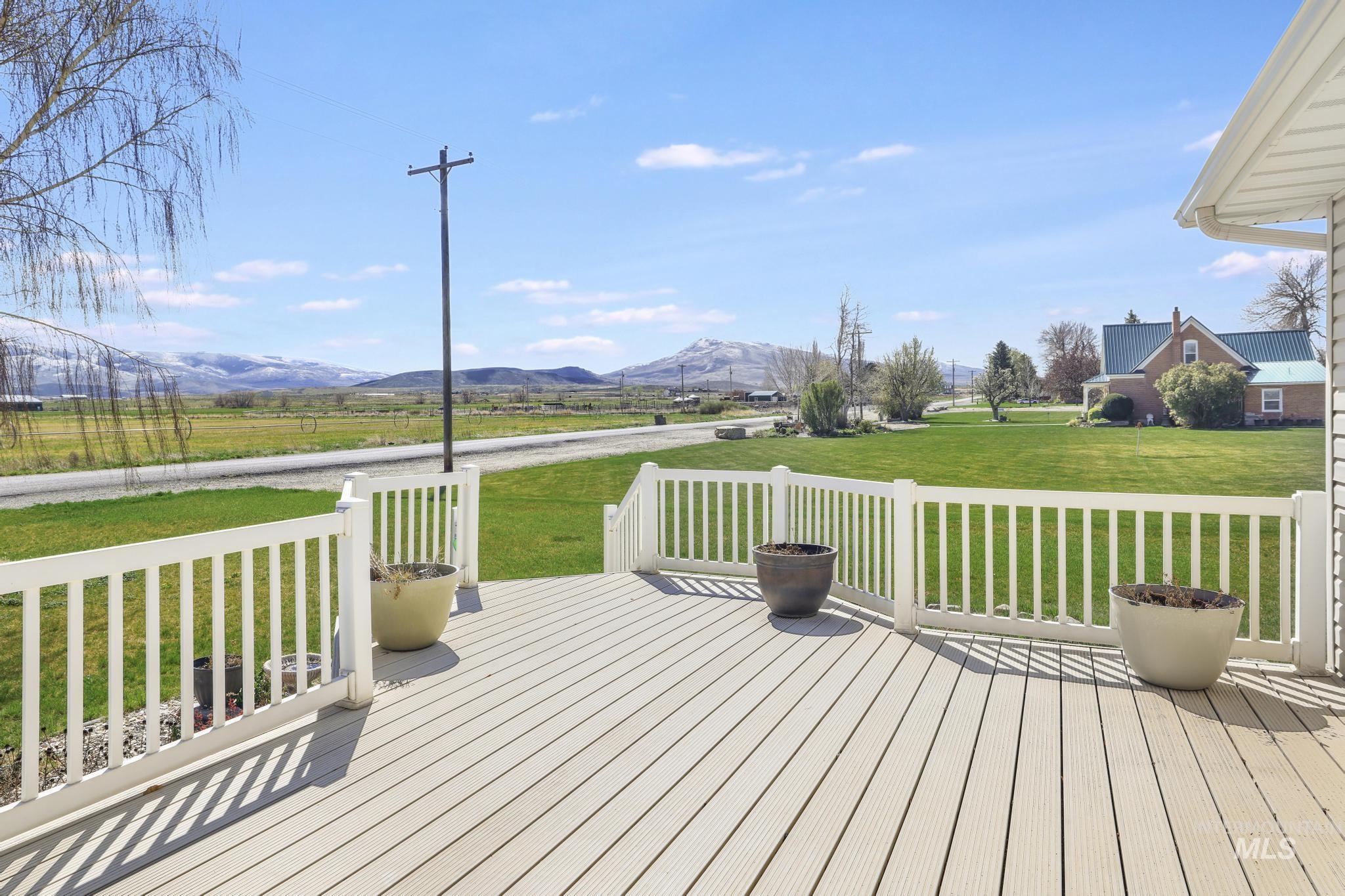 Wooden terrace with a mountain view and a yard